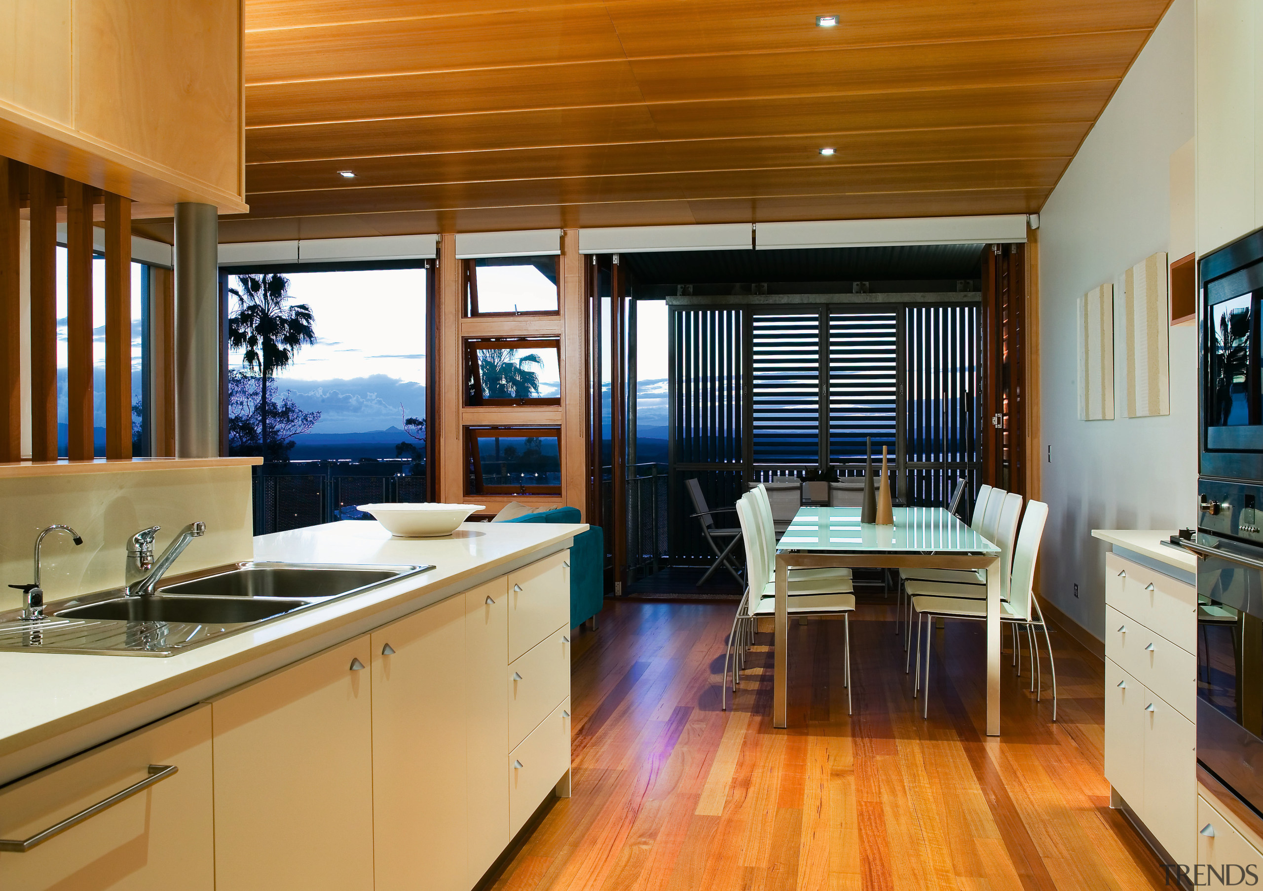 view of the kitchen featuring timber flooring, frosted countertop, interior design, kitchen, real estate, wood, brown, orange