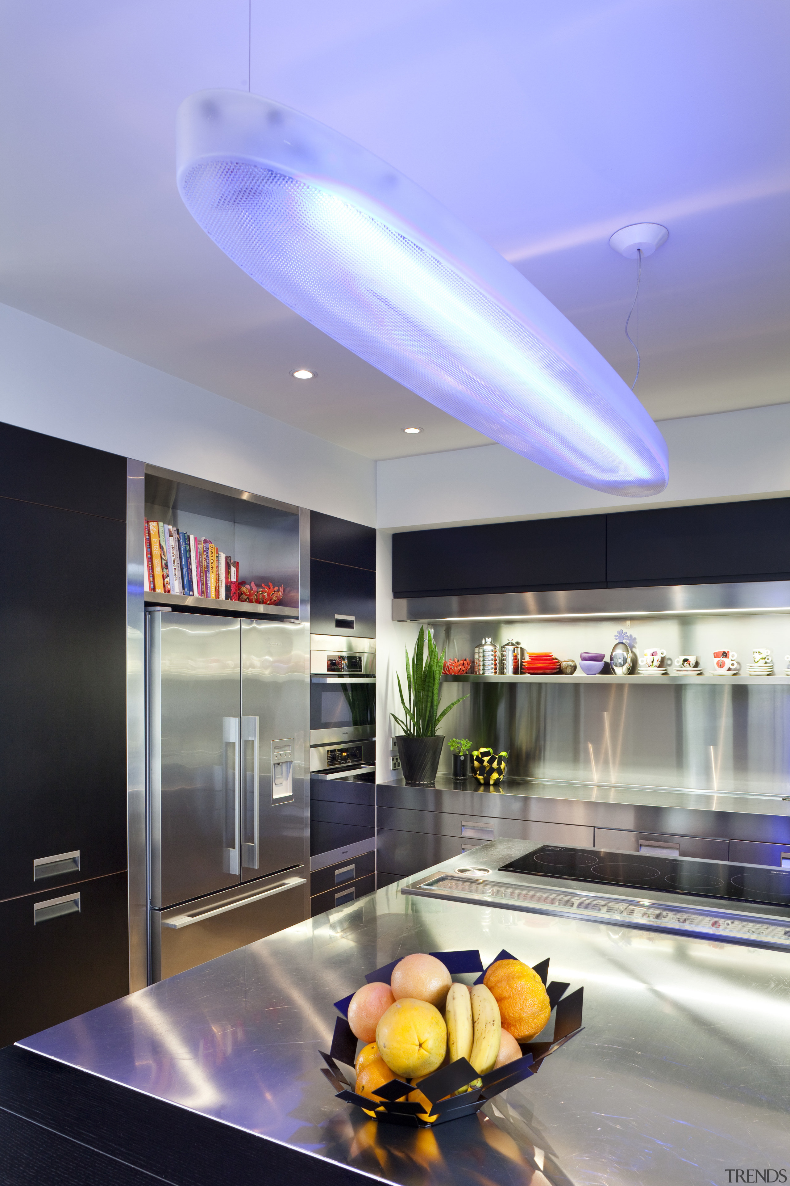 View of contemporary kitchen with stainless features, dark ceiling, interior design, lighting, blue, gray
