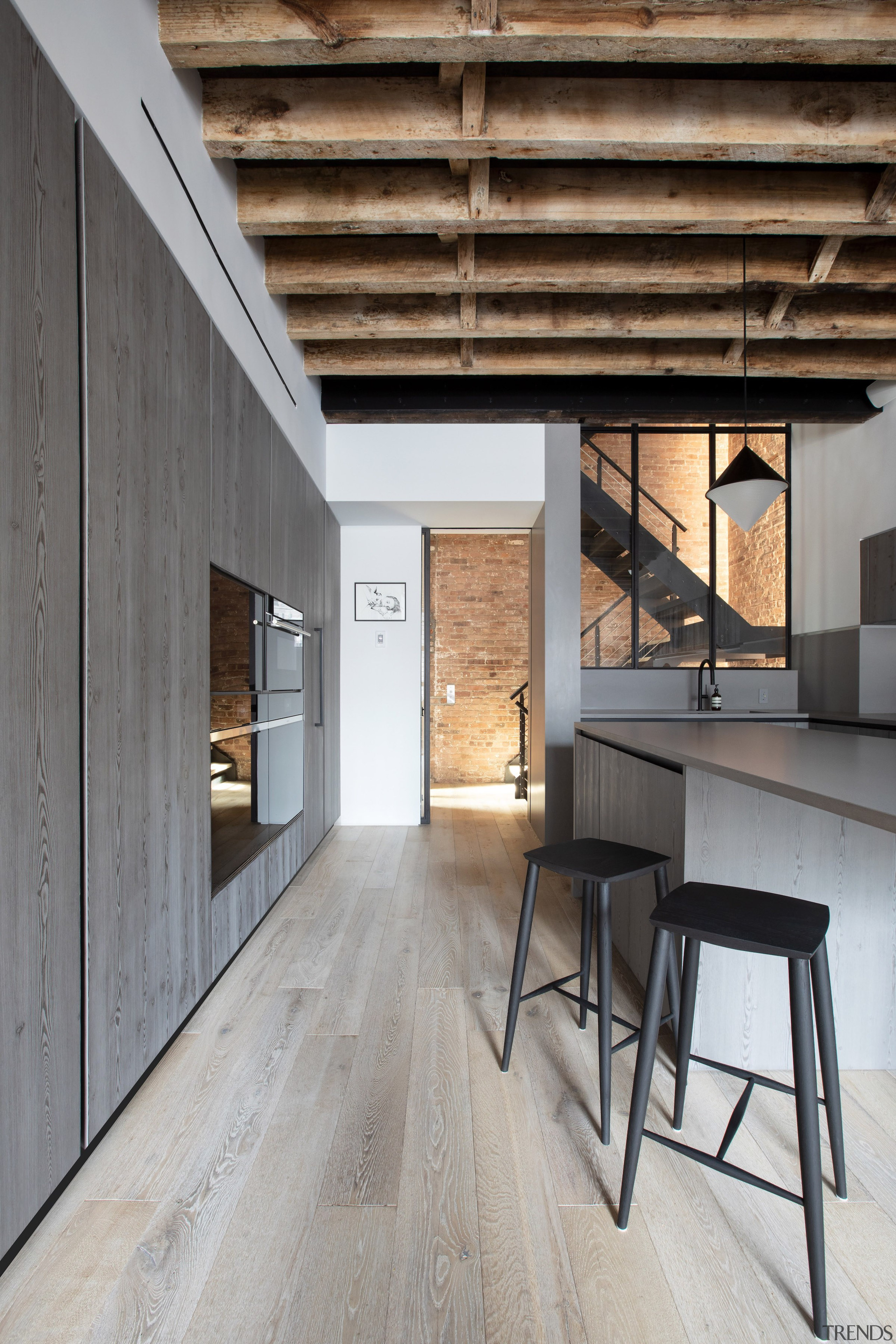 The raw exposed ceiling beams give the kitchen 