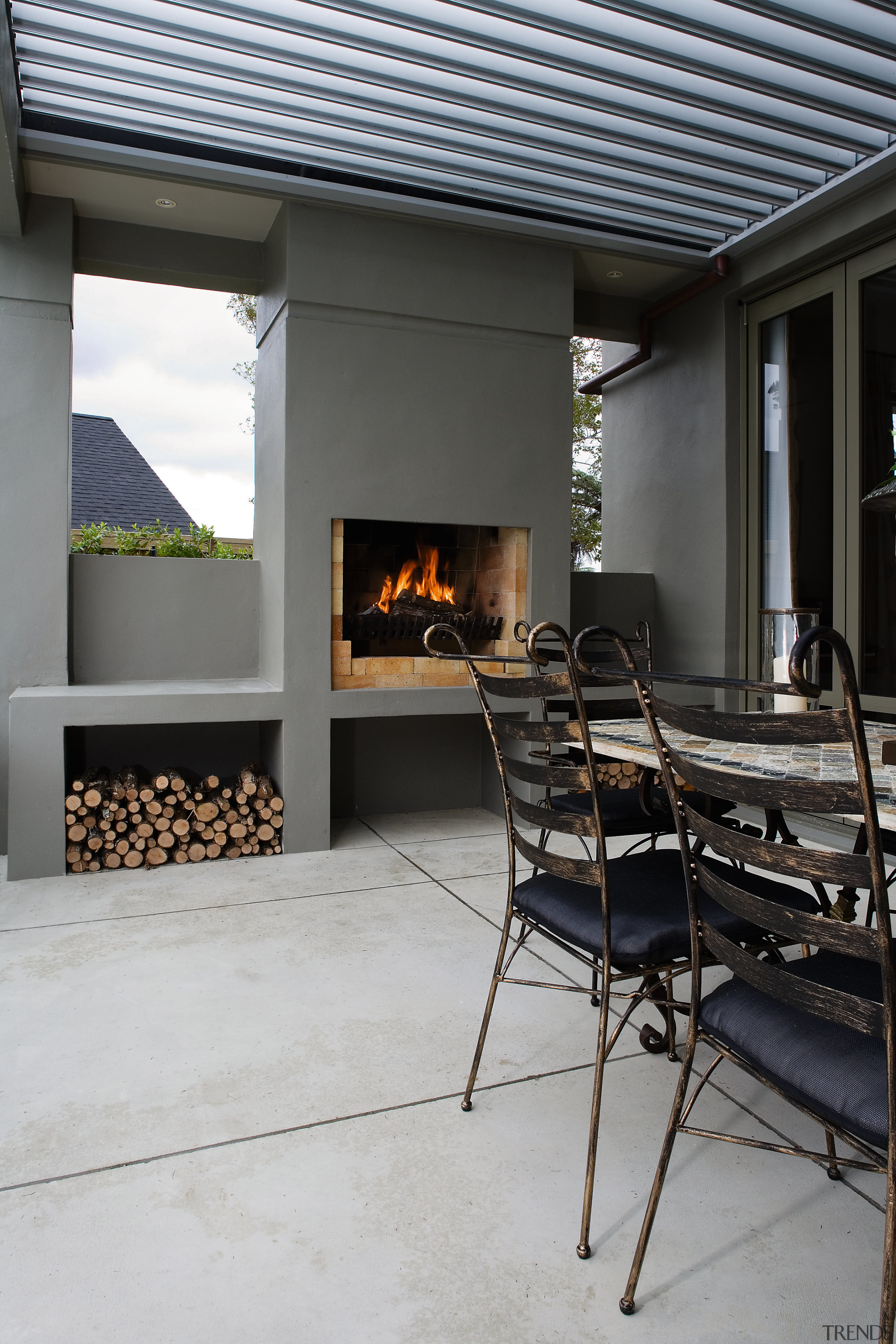 A view of some coloured concrete flooring by fireplace, floor, hearth, interior design, patio, gray, black