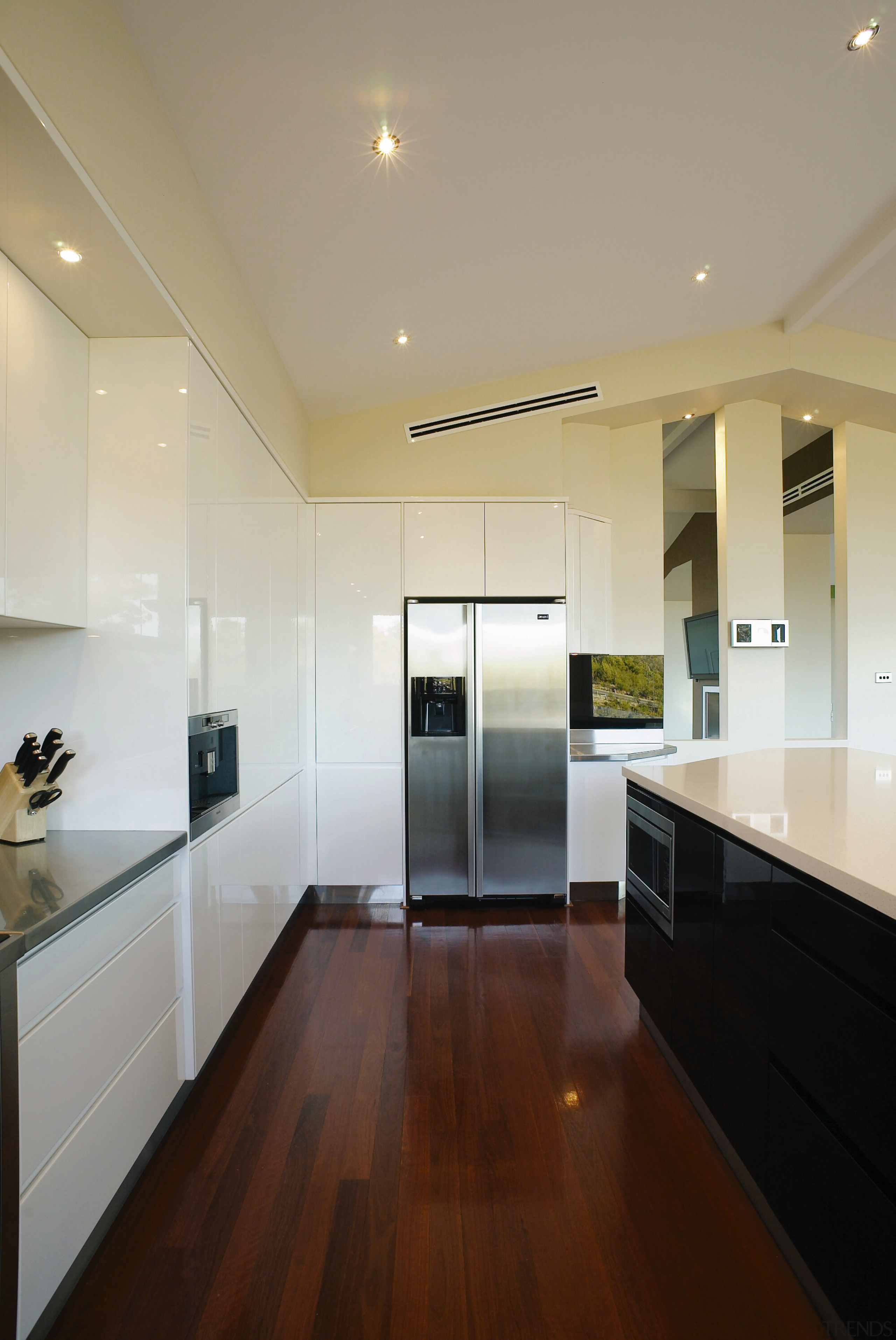 View of this Kitchen designed by Nouvelle Designer architecture, cabinetry, ceiling, countertop, daylighting, floor, flooring, hardwood, home, house, interior design, kitchen, laminate flooring, lighting, real estate, room, wall, window, wood flooring, orange