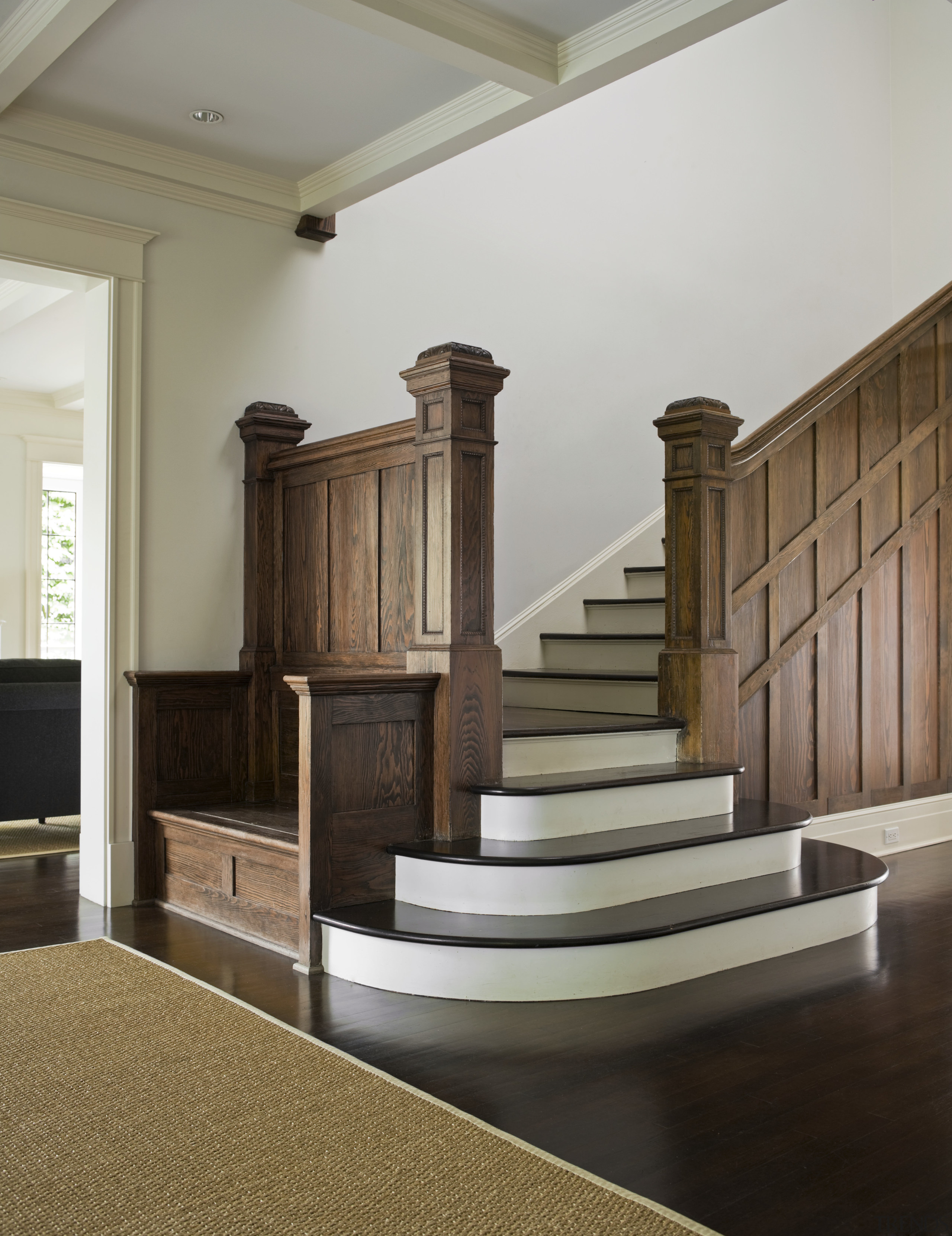 Image of hallway including staircase, featuring wooden ballustrade, baluster, column, floor, flooring, furniture, handrail, hardwood, home, interior design, lobby, stairs, structure, wall, wood, wood flooring, gray