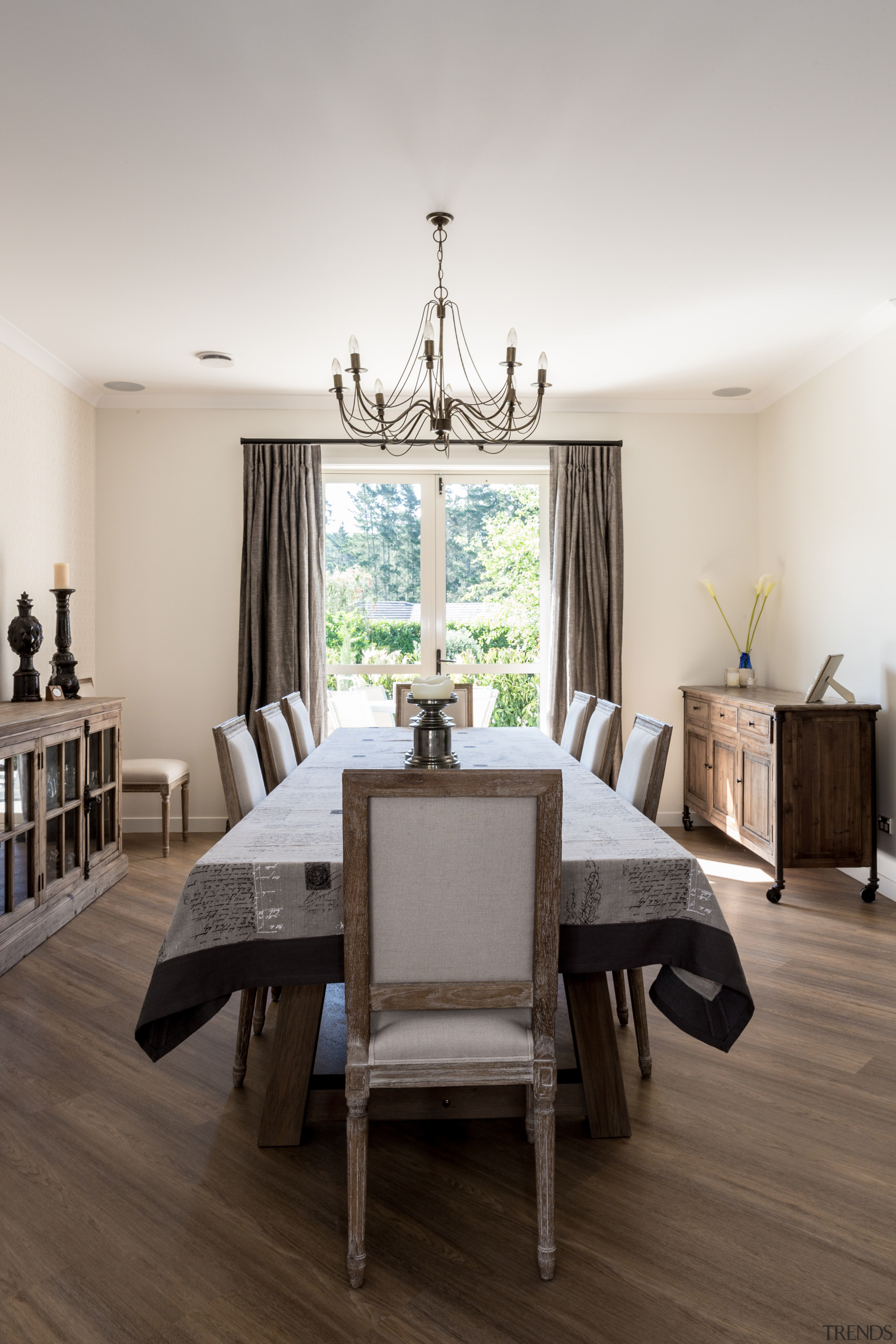 Full drapes frame the view from the dining ceiling, chair, dining room, floor, flooring, furniture, home, interior design, living room, room, table, white