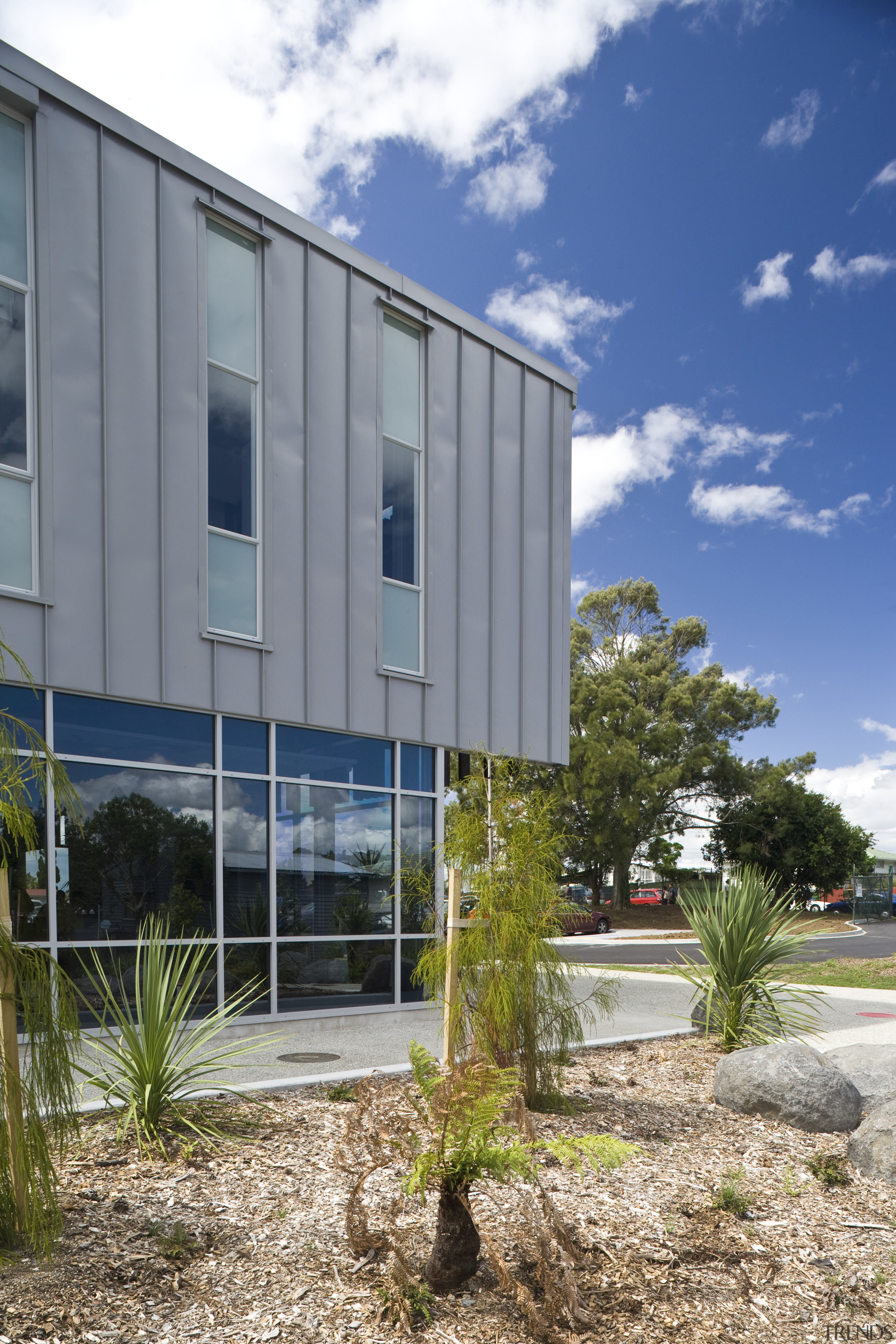 Exterior view of school which features cladding manufactured architecture, building, condominium, corporate headquarters, facade, home, house, property, real estate, sky, window, gray