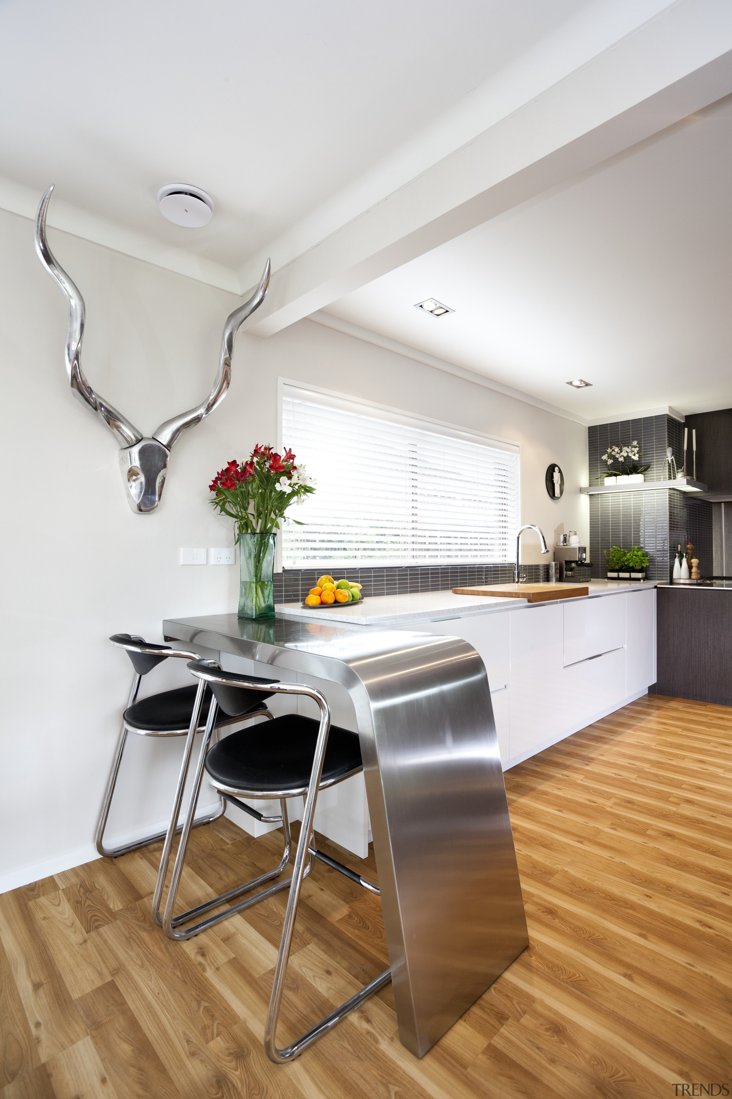 A view of the kitchen area. - A floor, flooring, house, interior design, kitchen, loft, real estate, room, table, white