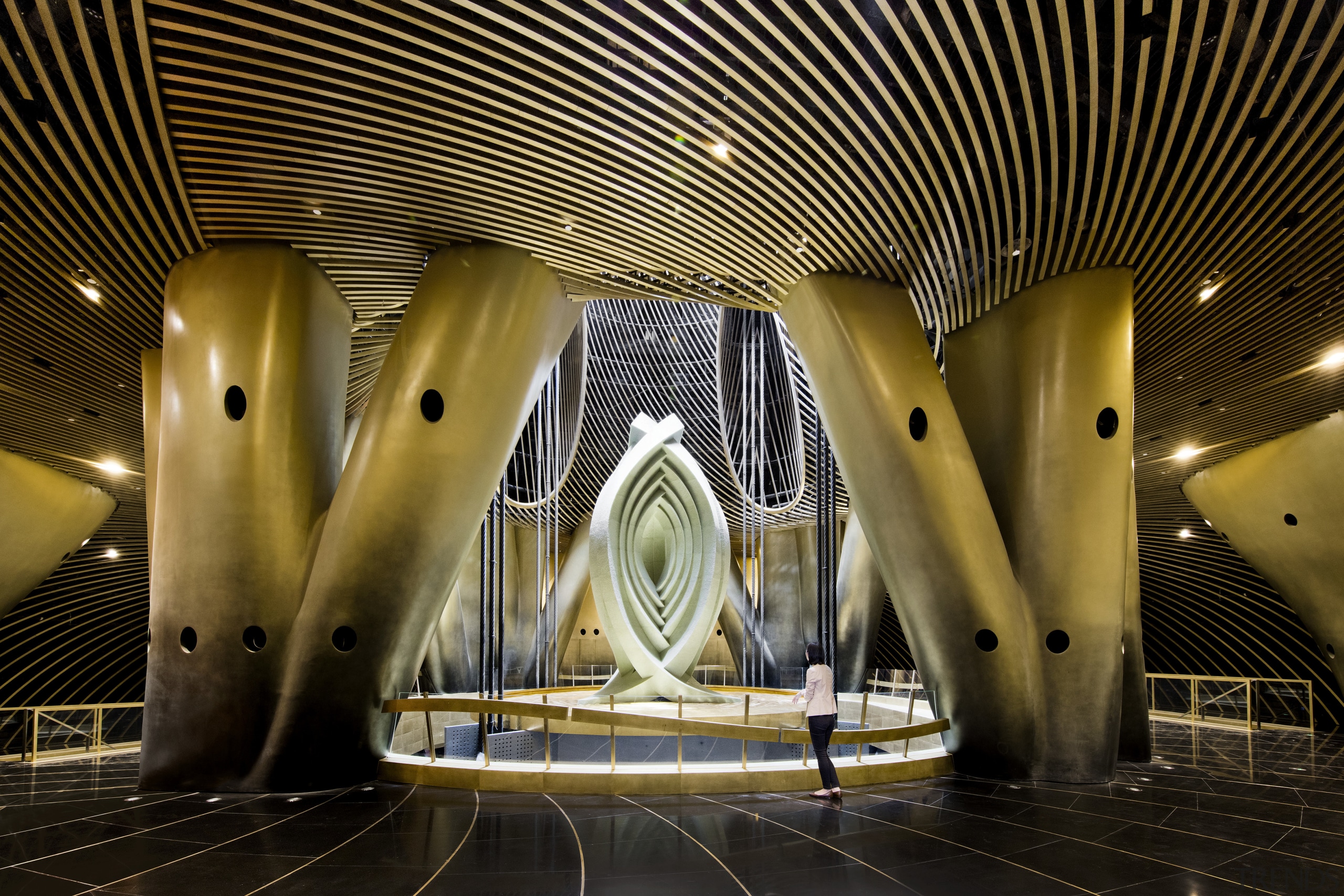 An artistic installation sits above the Shanghai Towers architecture, ceiling, light, lighting, night, performing arts center, structure, symmetry, black, brown