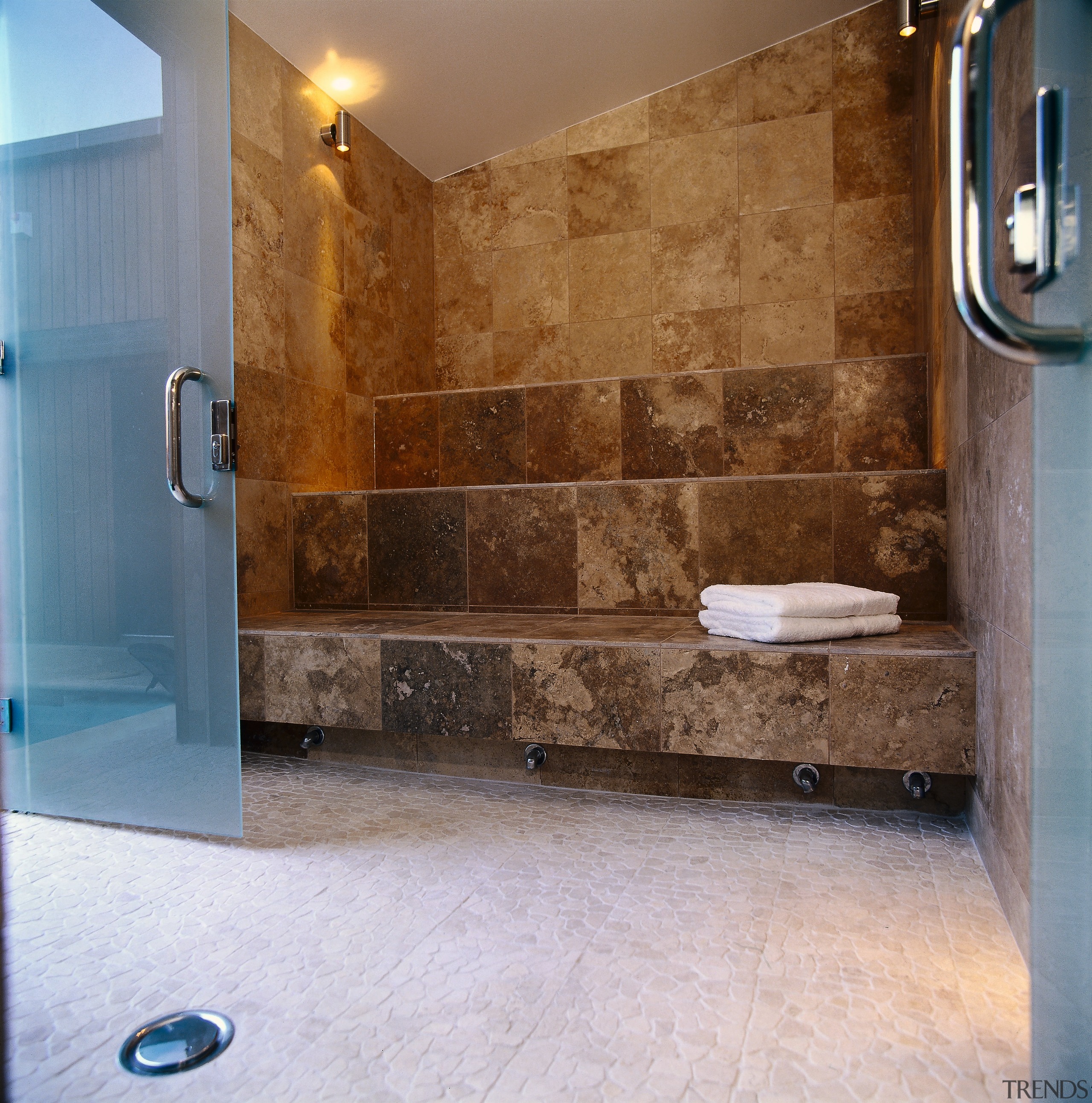 The view from a doorway into a steam bathroom, floor, flooring, interior design, plumbing fixture, room, tile, wall, brown