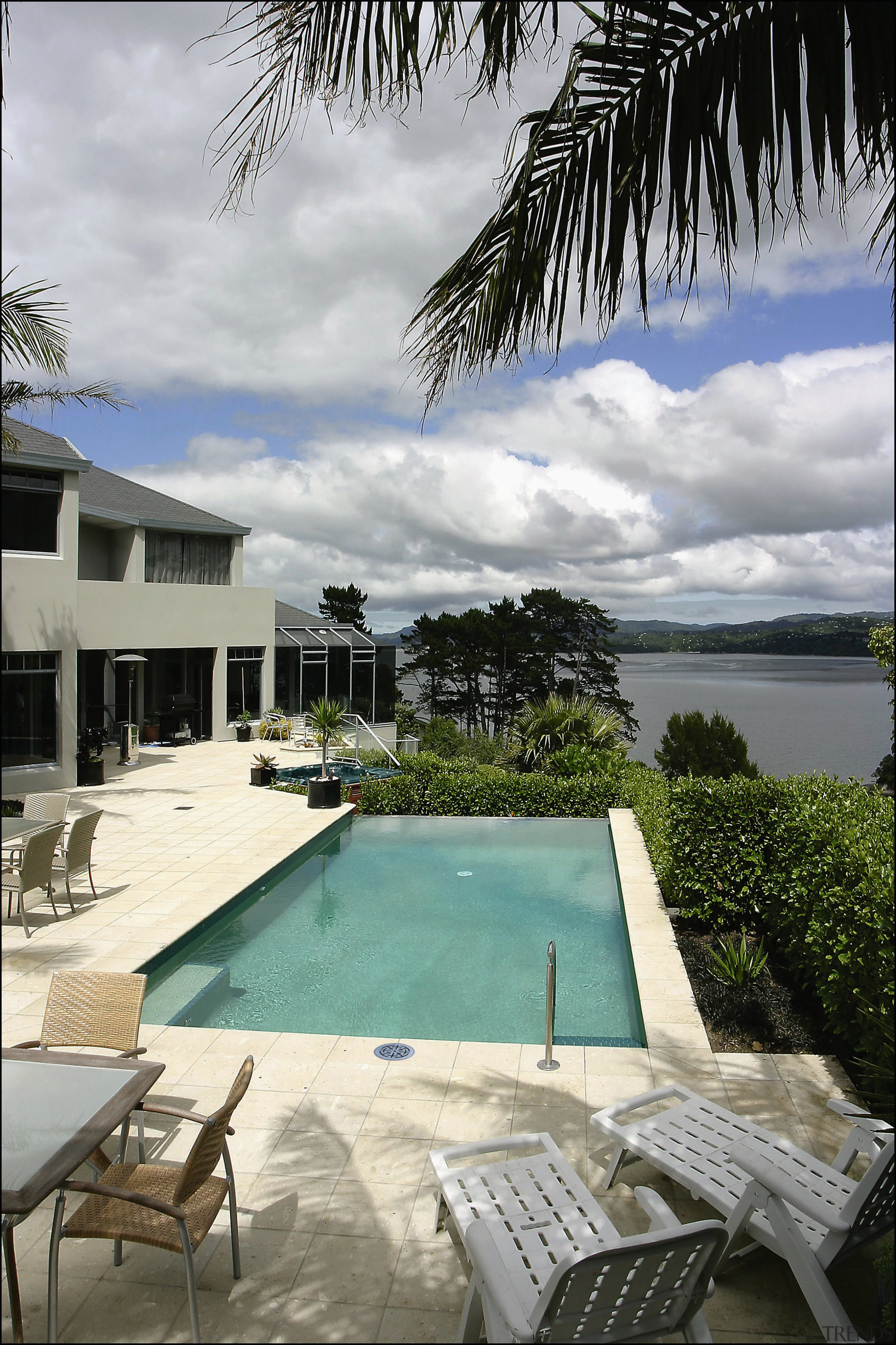 A view of some swimming pool grates. - arecales, condominium, estate, home, hotel, house, leisure, palm tree, property, real estate, resort, sea, sky, swimming pool, vacation, villa, water, gray