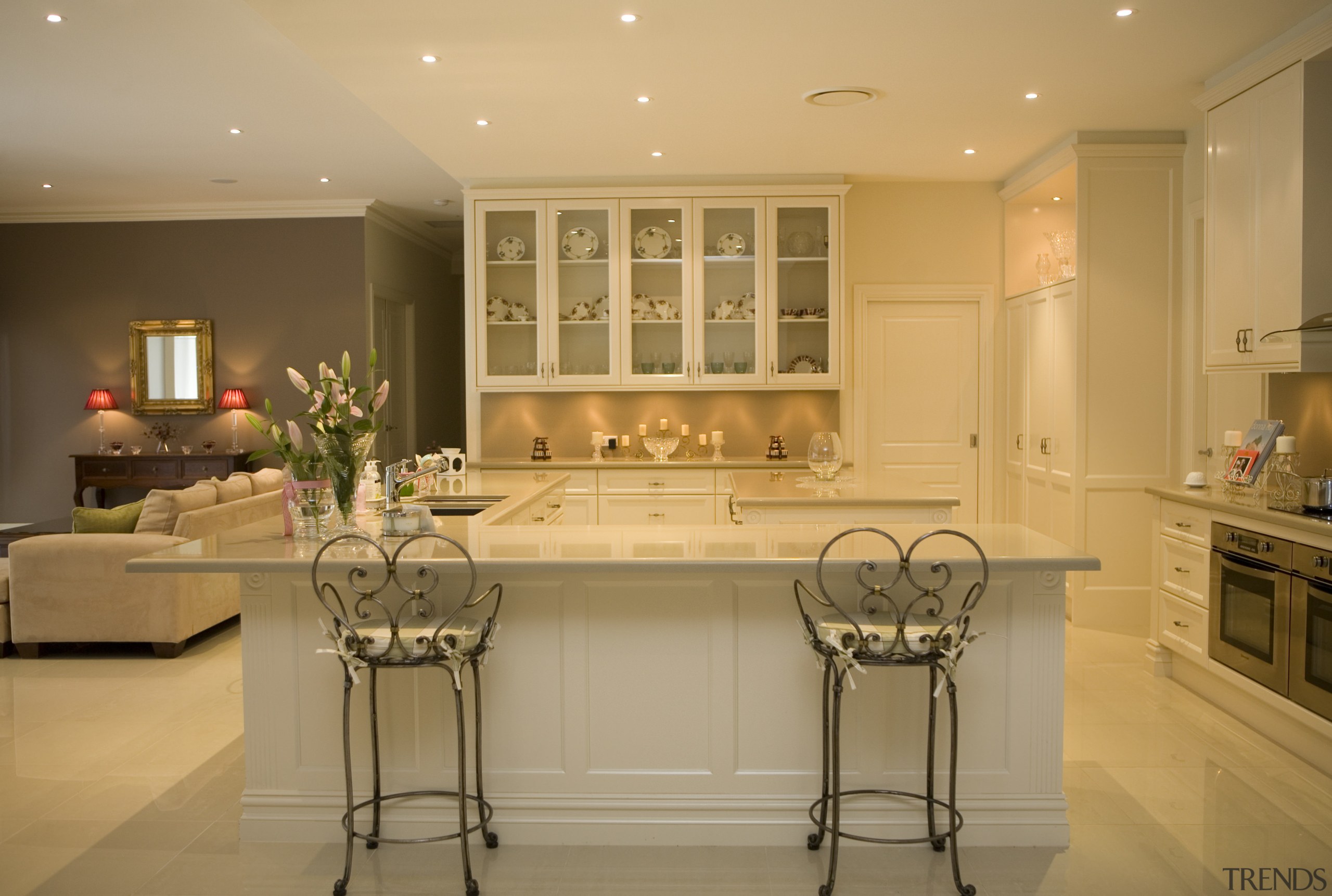 View of large, open-plan kitchen featuring overhead cabinetry cabinetry, ceiling, countertop, cuisine classique, dining room, flooring, home, interior design, kitchen, room, under cabinet lighting, orange, brown