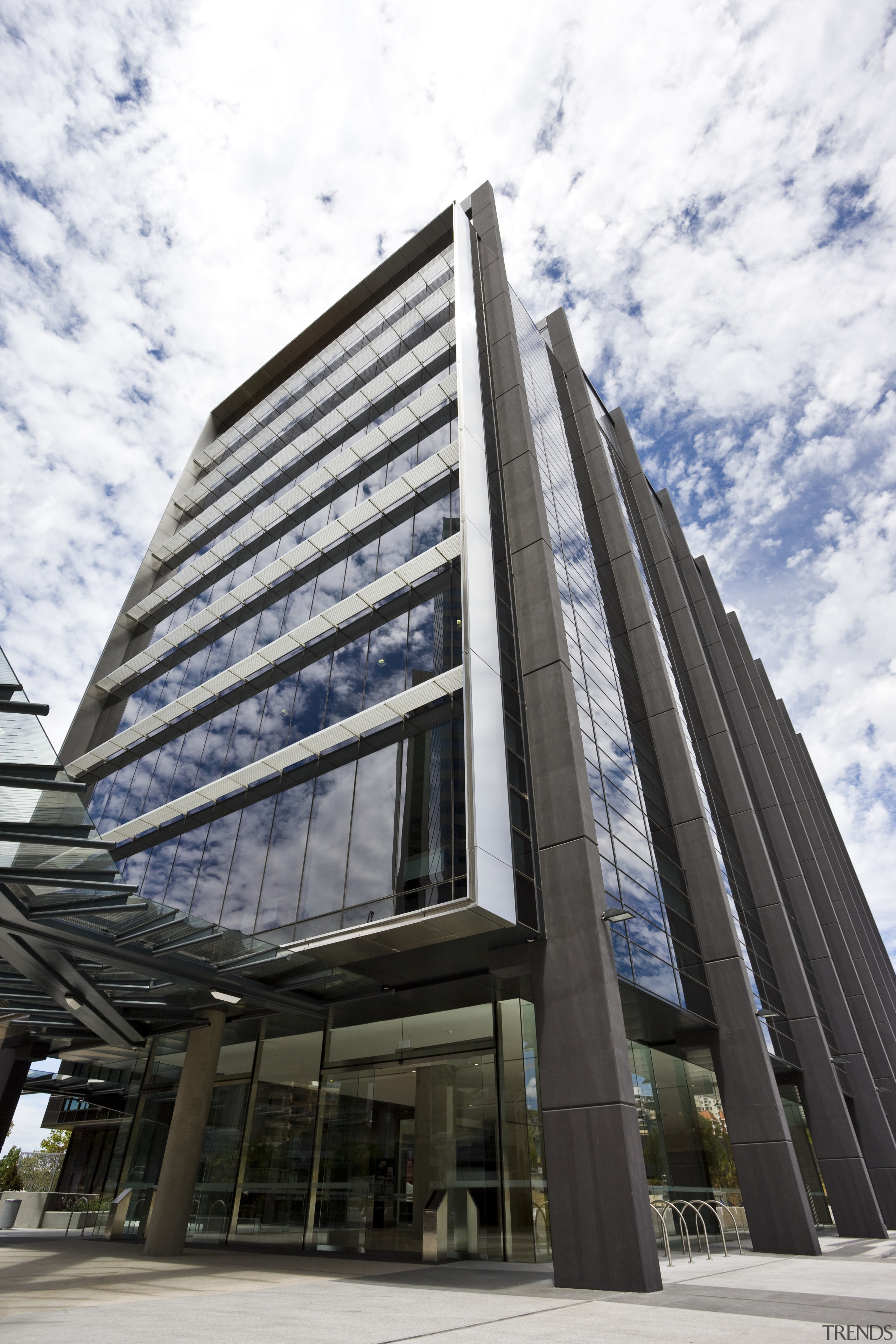 Exterior view of the eco-friendly commercial office tower architecture, brutalist architecture, building, commercial building, condominium, corporate headquarters, daytime, facade, headquarters, landmark, metropolis, metropolitan area, mixed use, sky, skyscraper, tower block, white, black