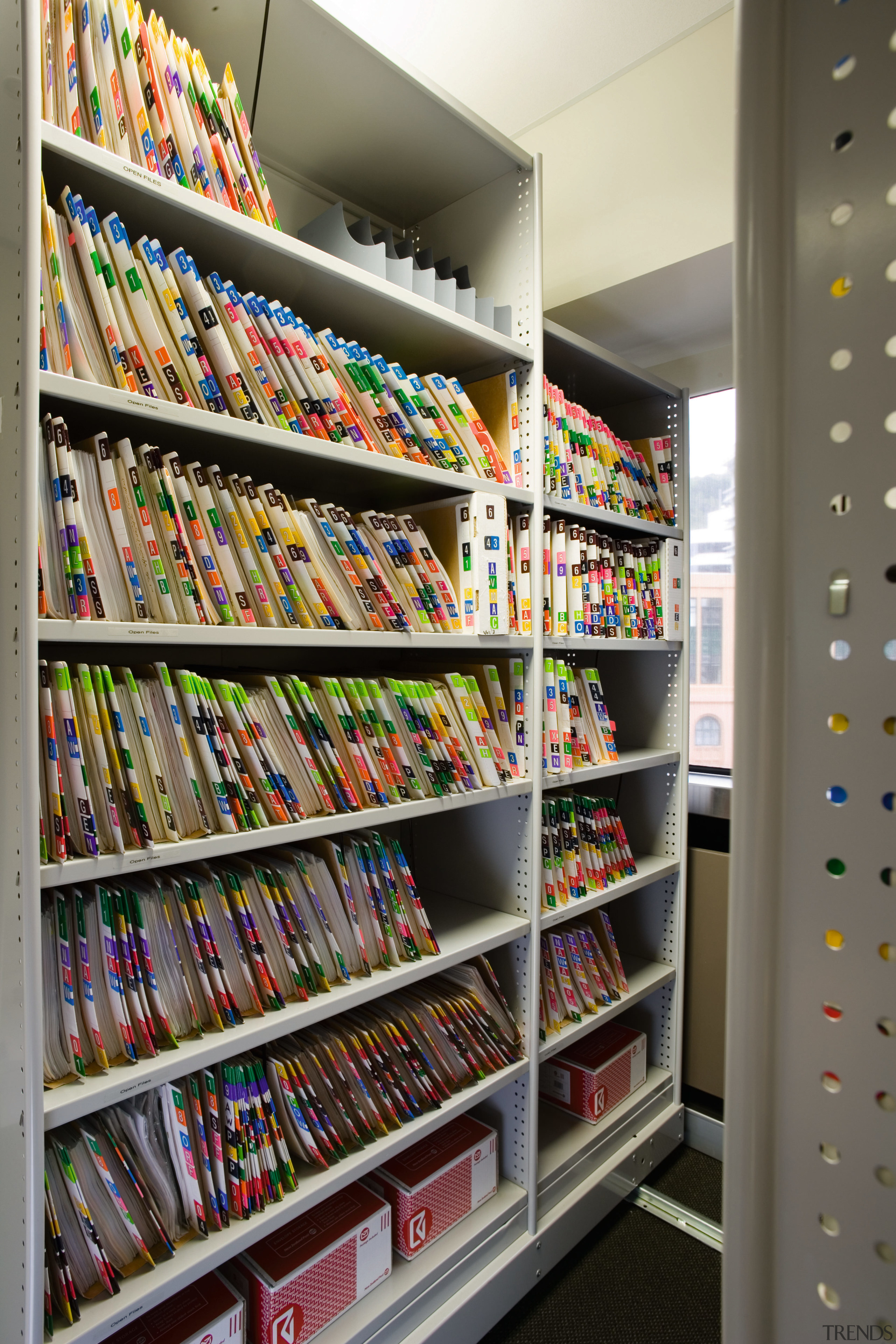 A view of some storage shelving units. - bookcase, convenience store, inventory, library, product, retail, shelf, shelving, supermarket, gray