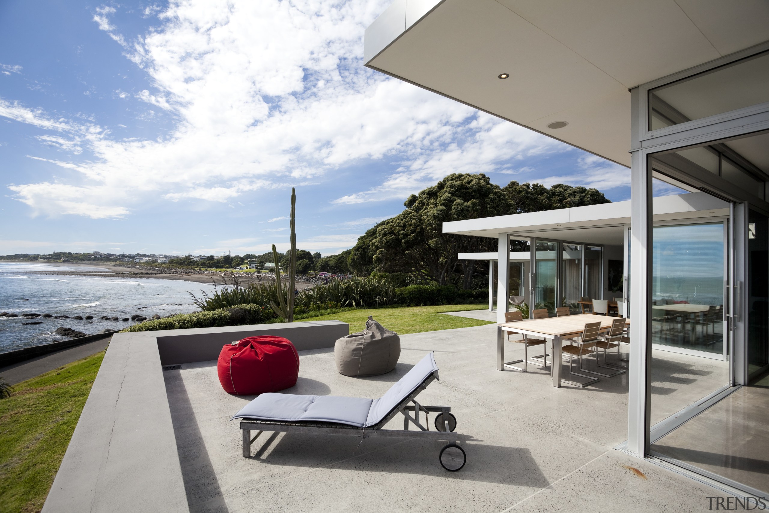 Outdoor view, patio overlooking beach, outdoor furniture, glass architecture, home, house, interior design, outdoor furniture, property, real estate, sunlounger, vacation, window, gray