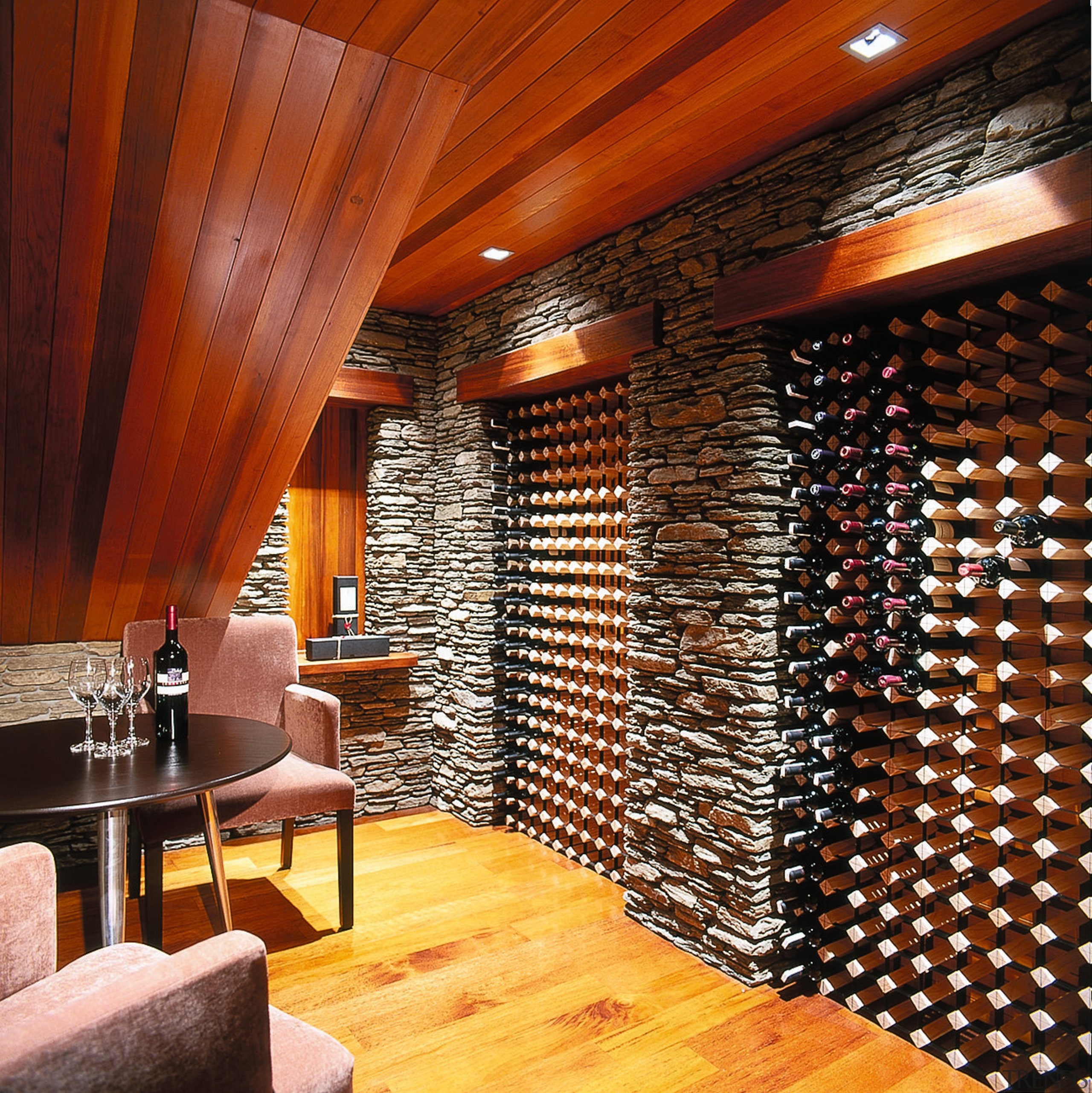 Inner view of wine cellar. Features a raked ceiling, flooring, interior design, lobby, wall, wine cellar, wood, red