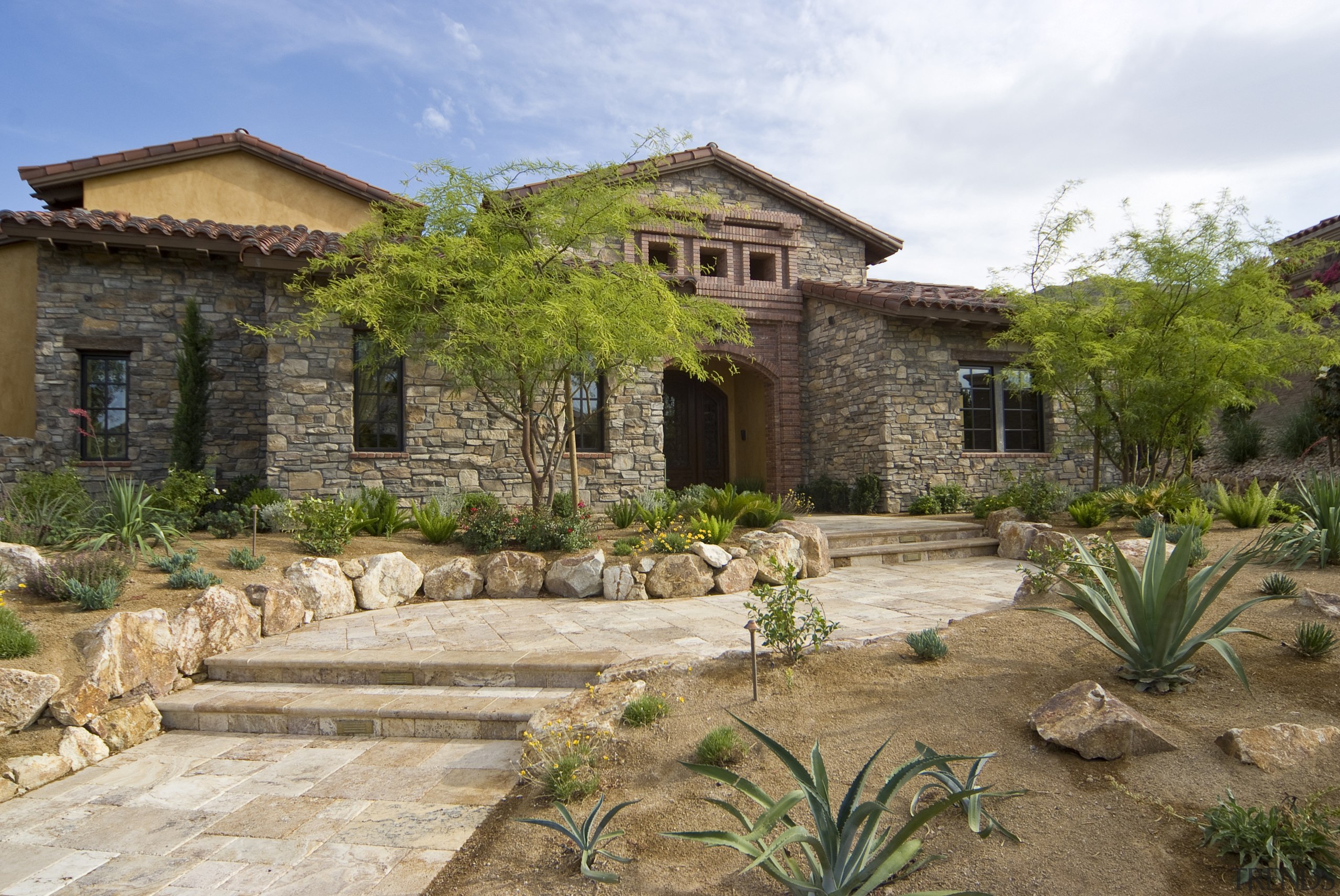 Exterior view of residence which was built by backyard, cottage, courtyard, estate, facade, garden, hacienda, home, house, landscape, landscaping, mansion, outdoor structure, property, real estate, villa, yard, brown