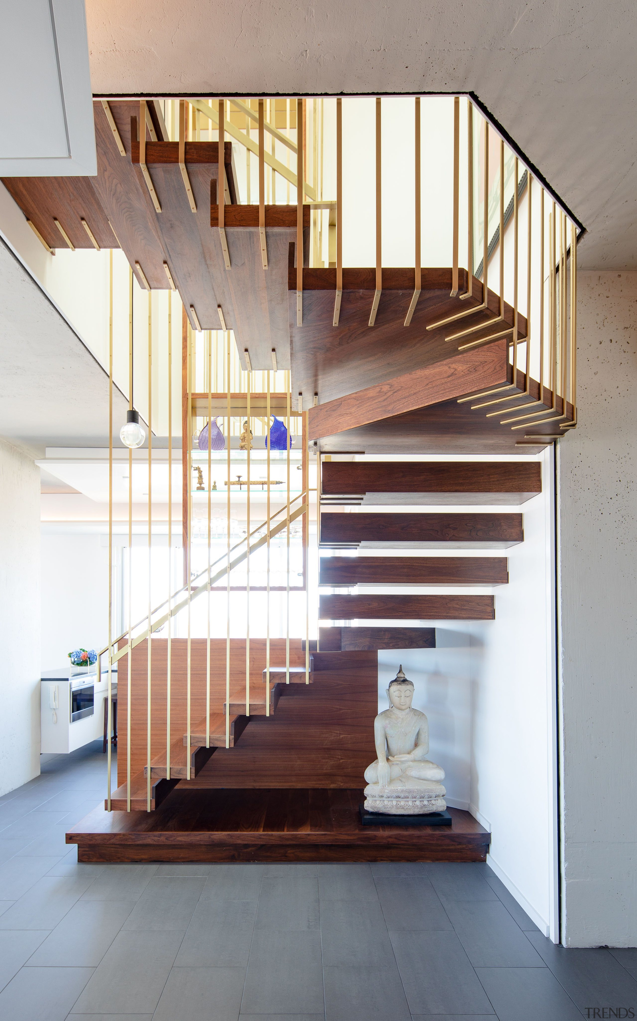 ​​​​​​​Steel rods dipped in brass are suspended 7.3m architecture, Penthouse, stairway, handrail, home, interior design, stairs, wood, suspended stairway, Andrew Wilkinson