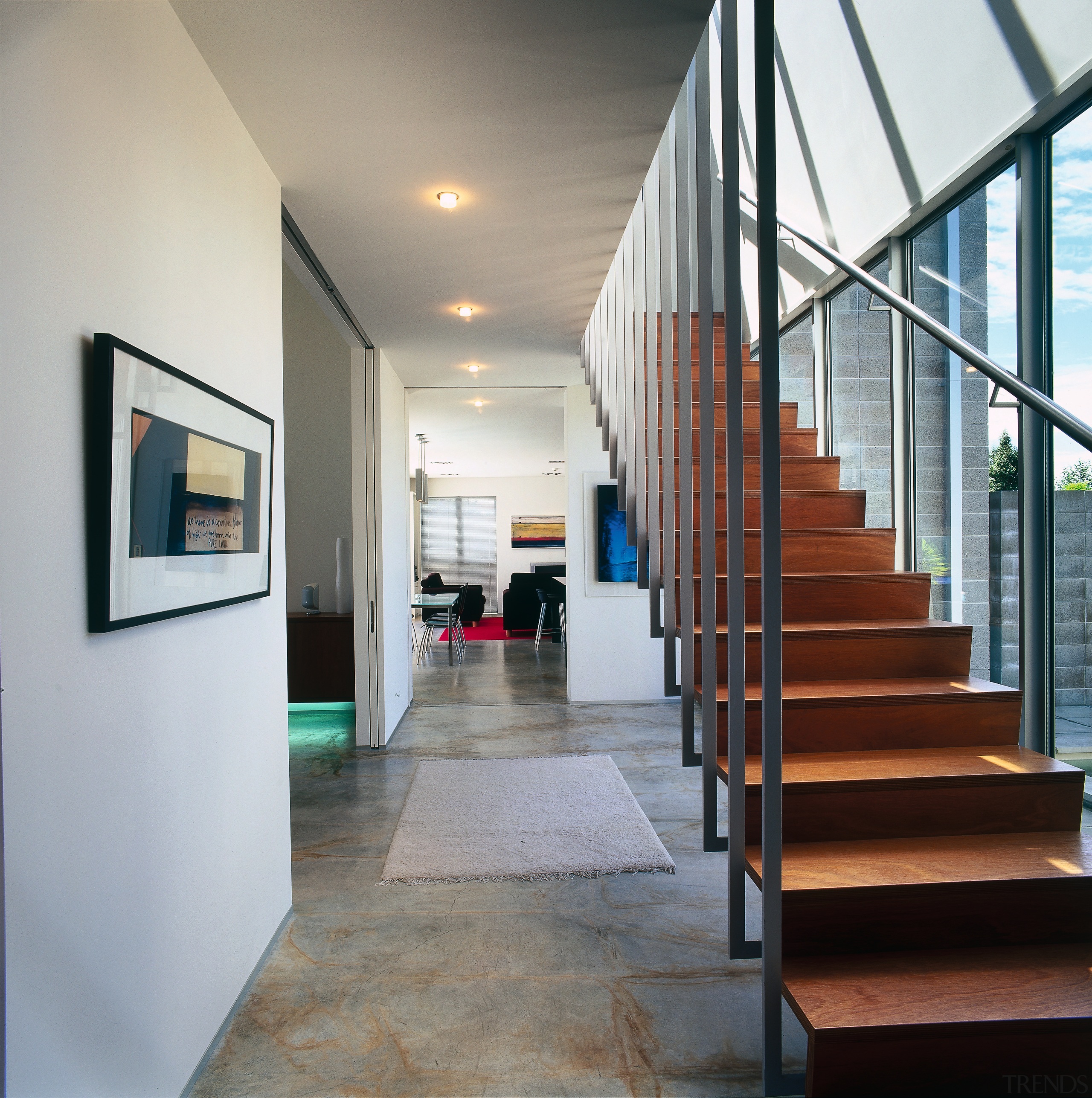 A view of the staircase featuring polished timber architecture, ceiling, daylighting, floor, flooring, handrail, house, interior design, lobby, real estate, stairs, gray