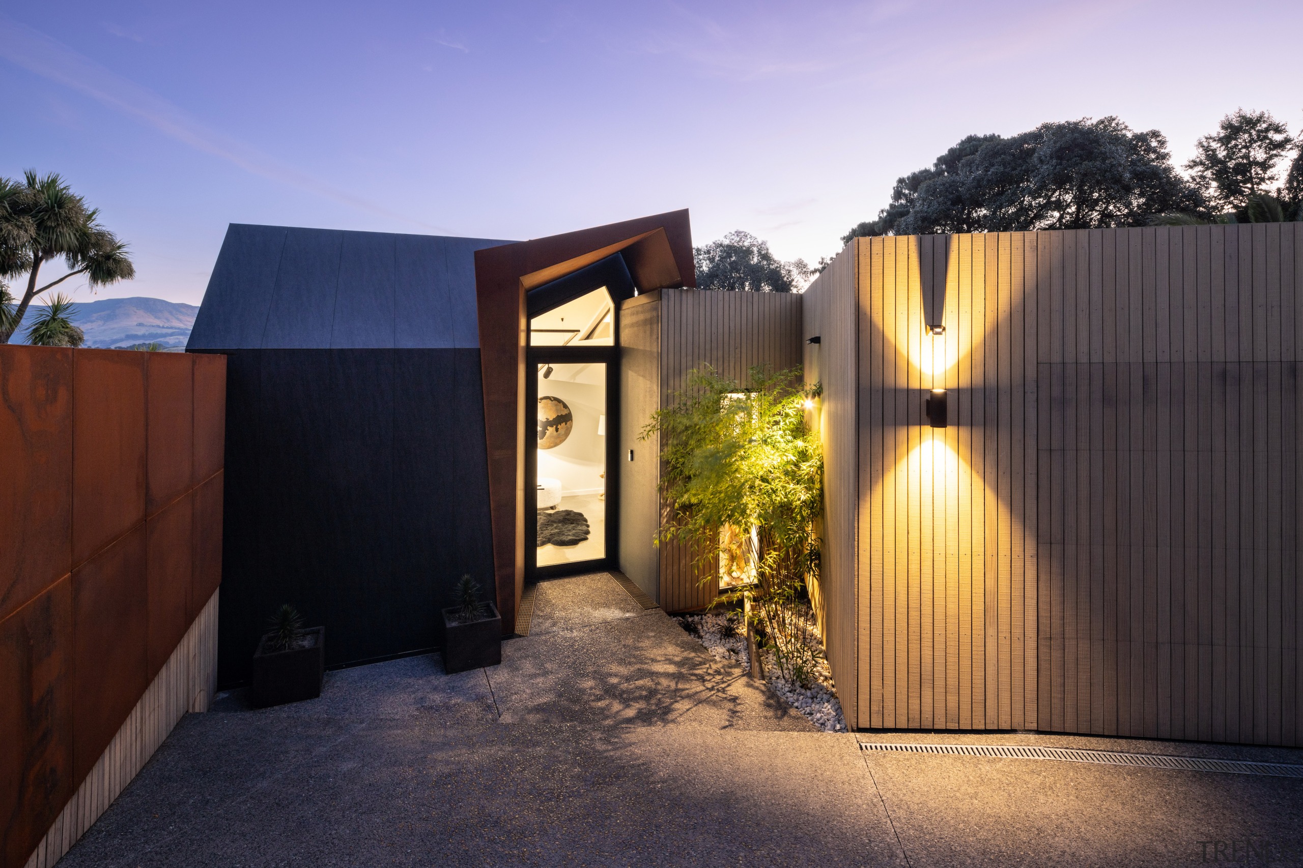 A sculptural Corten steel portal stands in the 