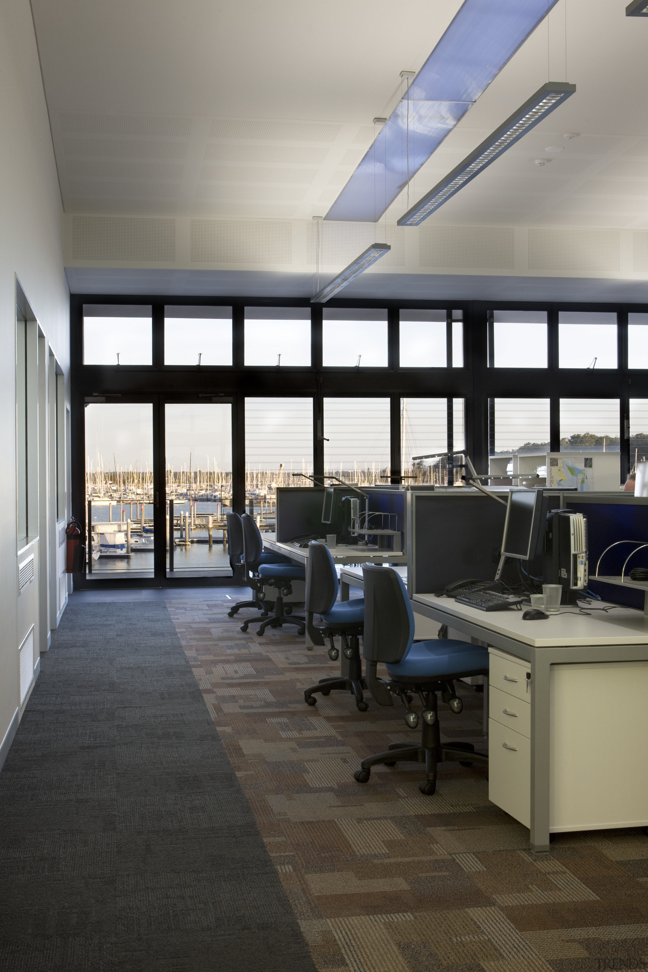 View of an office work stations which feature ceiling, floor, flooring, interior design, office, gray, black