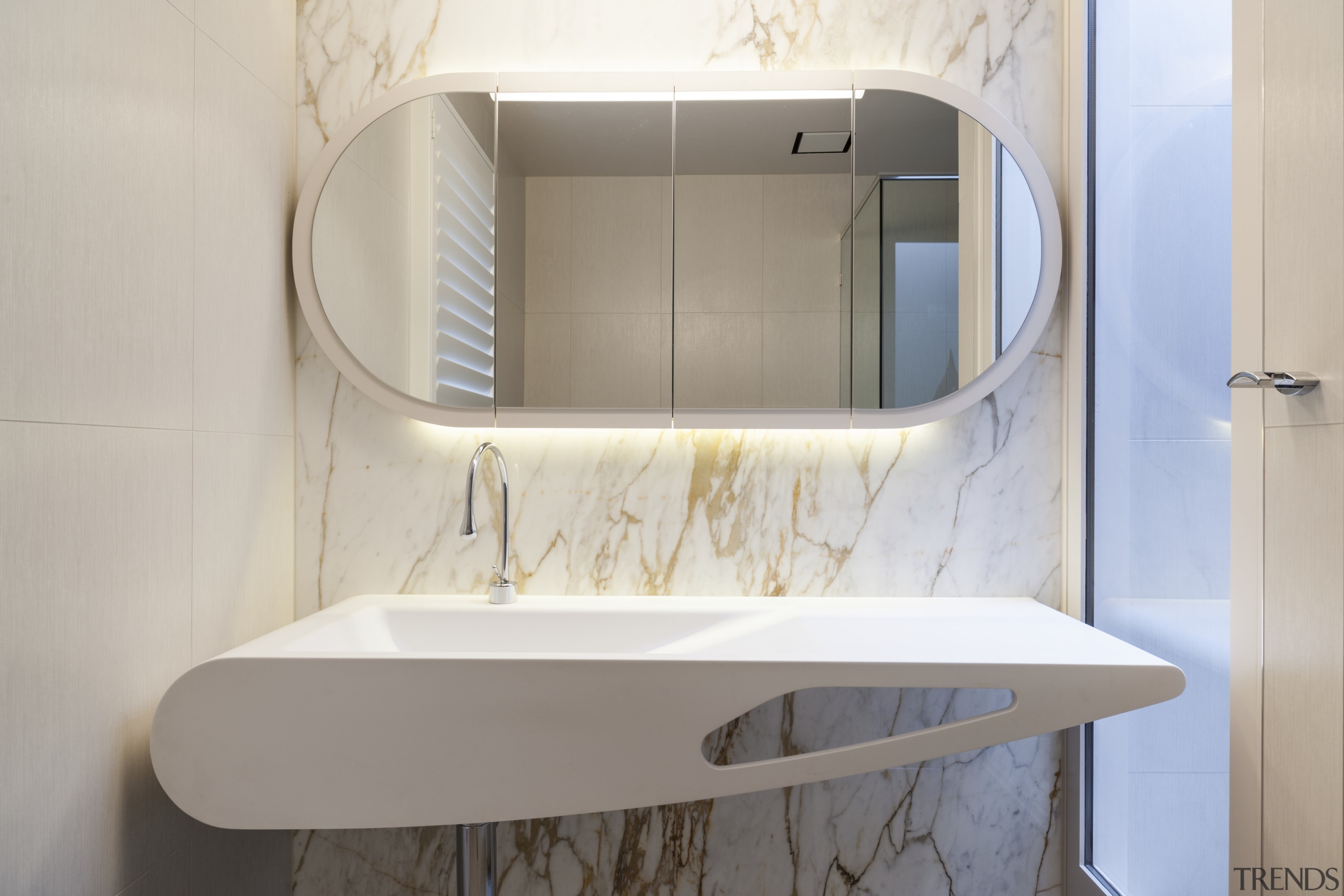 In this design, a richly veined marble feature bathroom, bathroom accessory, bathroom cabinet, bathroom sink, furniture, interior design, plumbing fixture, product, product design, sink, tap, gray