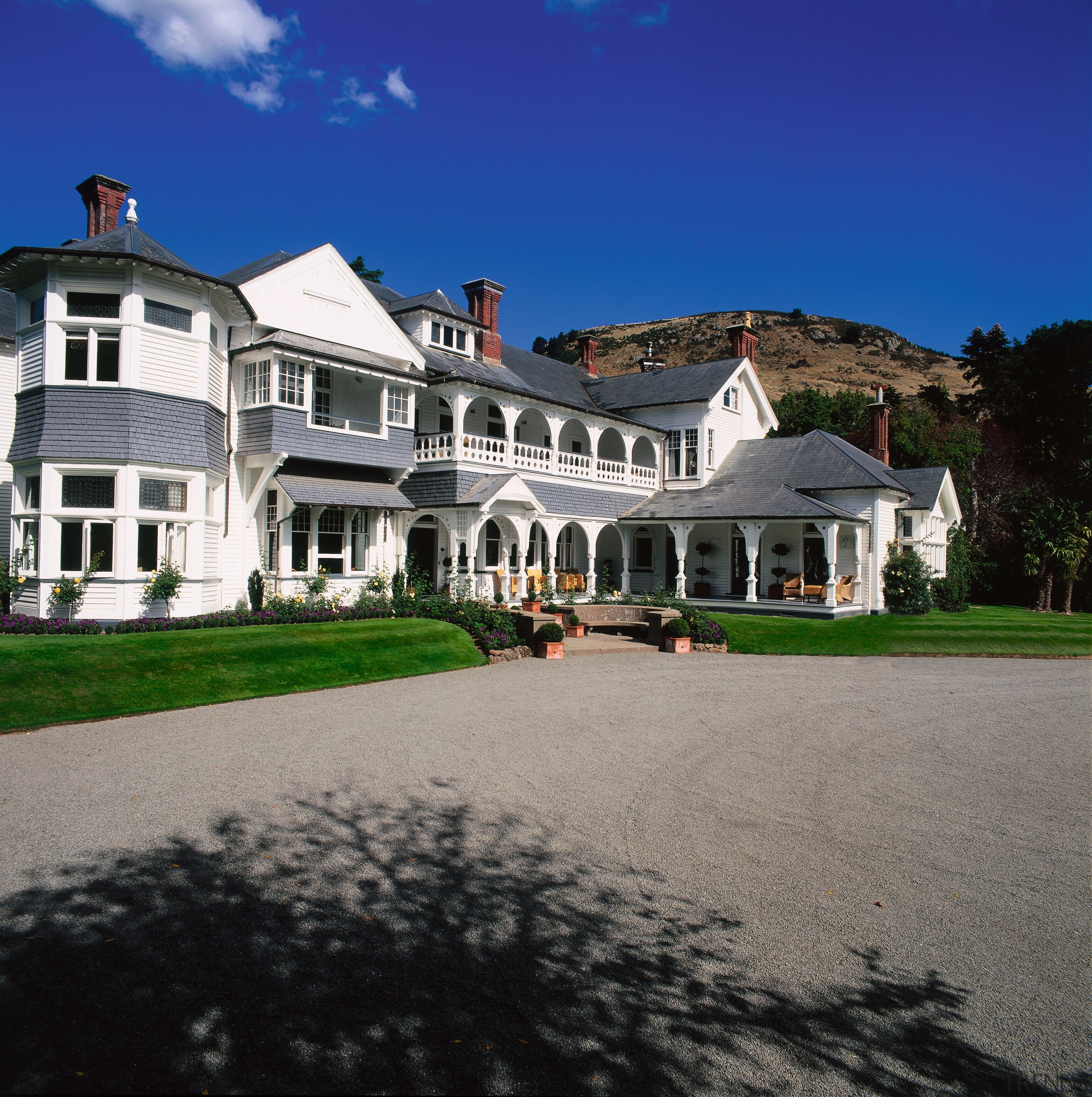 The view of a historical styled lodge - building, cottage, estate, facade, farmhouse, historic house, home, house, manor house, mansion, property, real estate, residential area, sky, suburb, villa, window, gray, black, blue