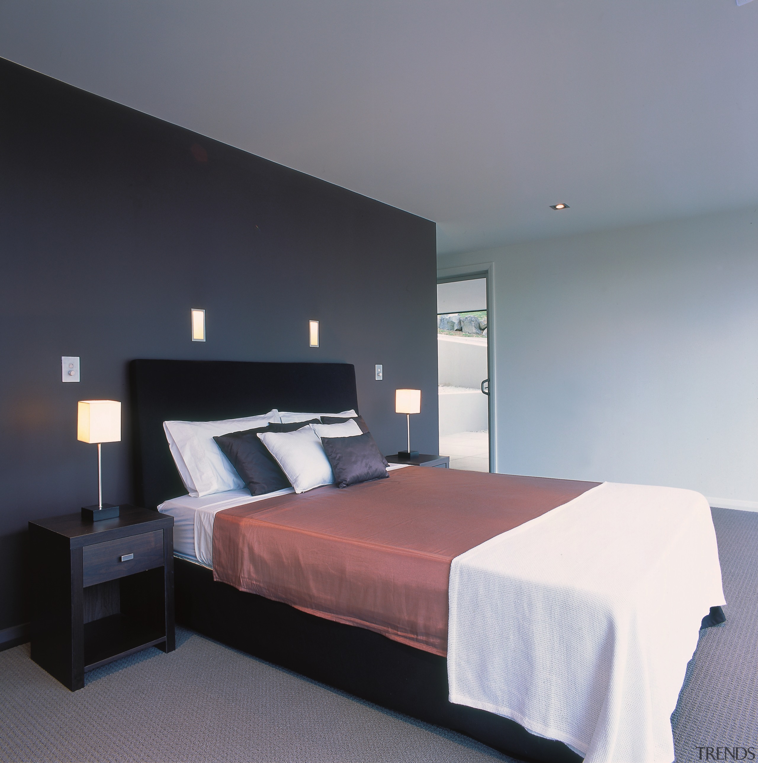 Bedroom with dark coloured feature wall and cabinets. architecture, bed, bed frame, bedroom, ceiling, interior design, mattress, room, suite, wall, gray, black