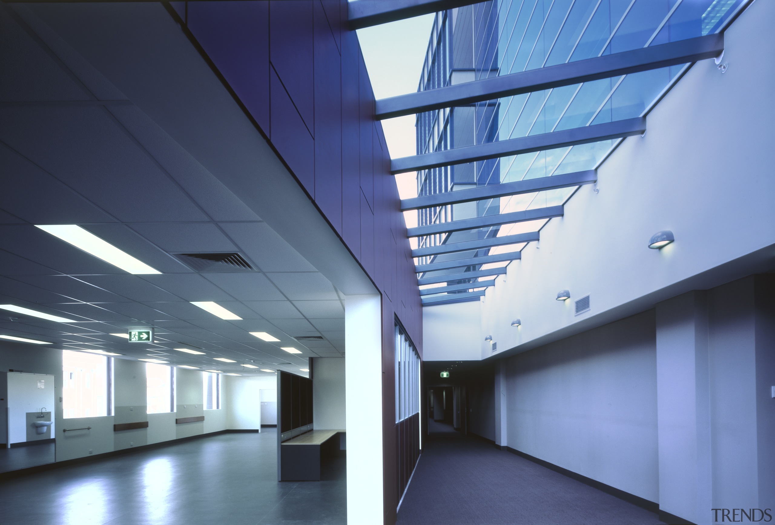 A skylight along the lenght of the building's architecture, ceiling, commercial building, corporate headquarters, daylighting, daytime, glass, headquarters, interior design, line, structure, teal, blue