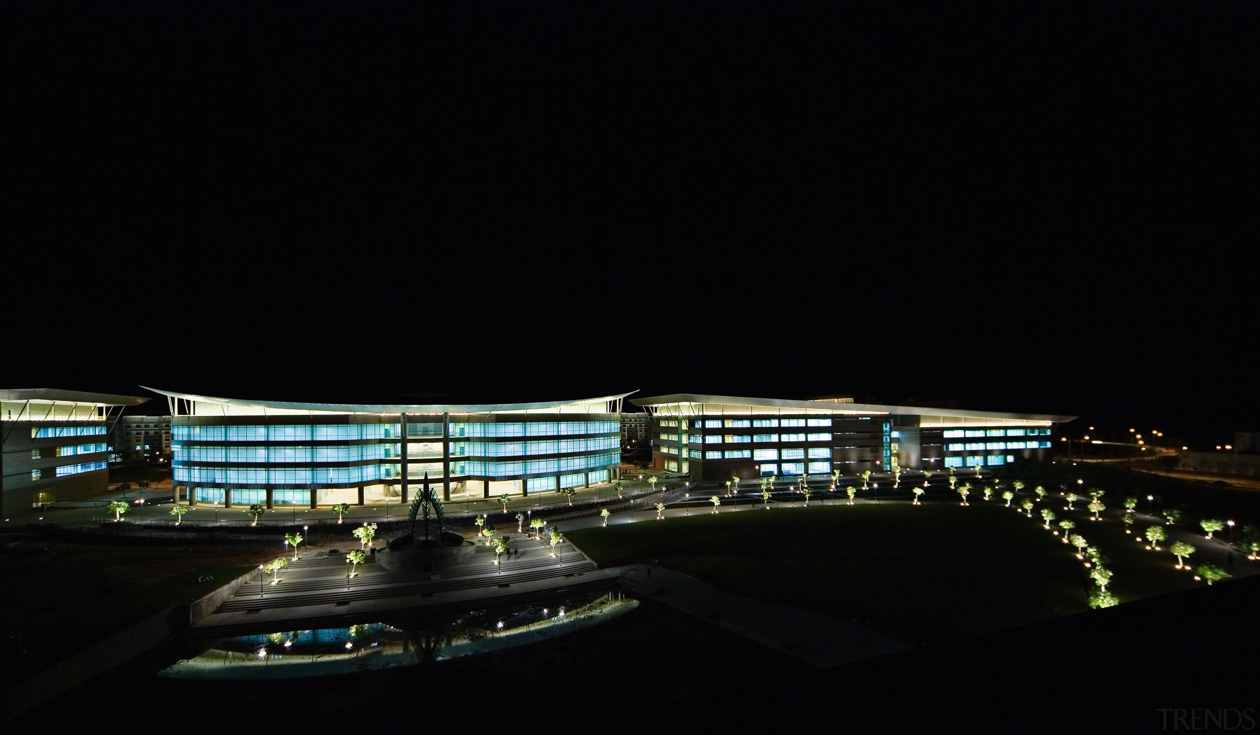 view of the exterior and glass facade of architecture, atmosphere, city, cityscape, darkness, infrastructure, landmark, light, metropolis, metropolitan area, night, reflection, sky, structure, urban area, black
