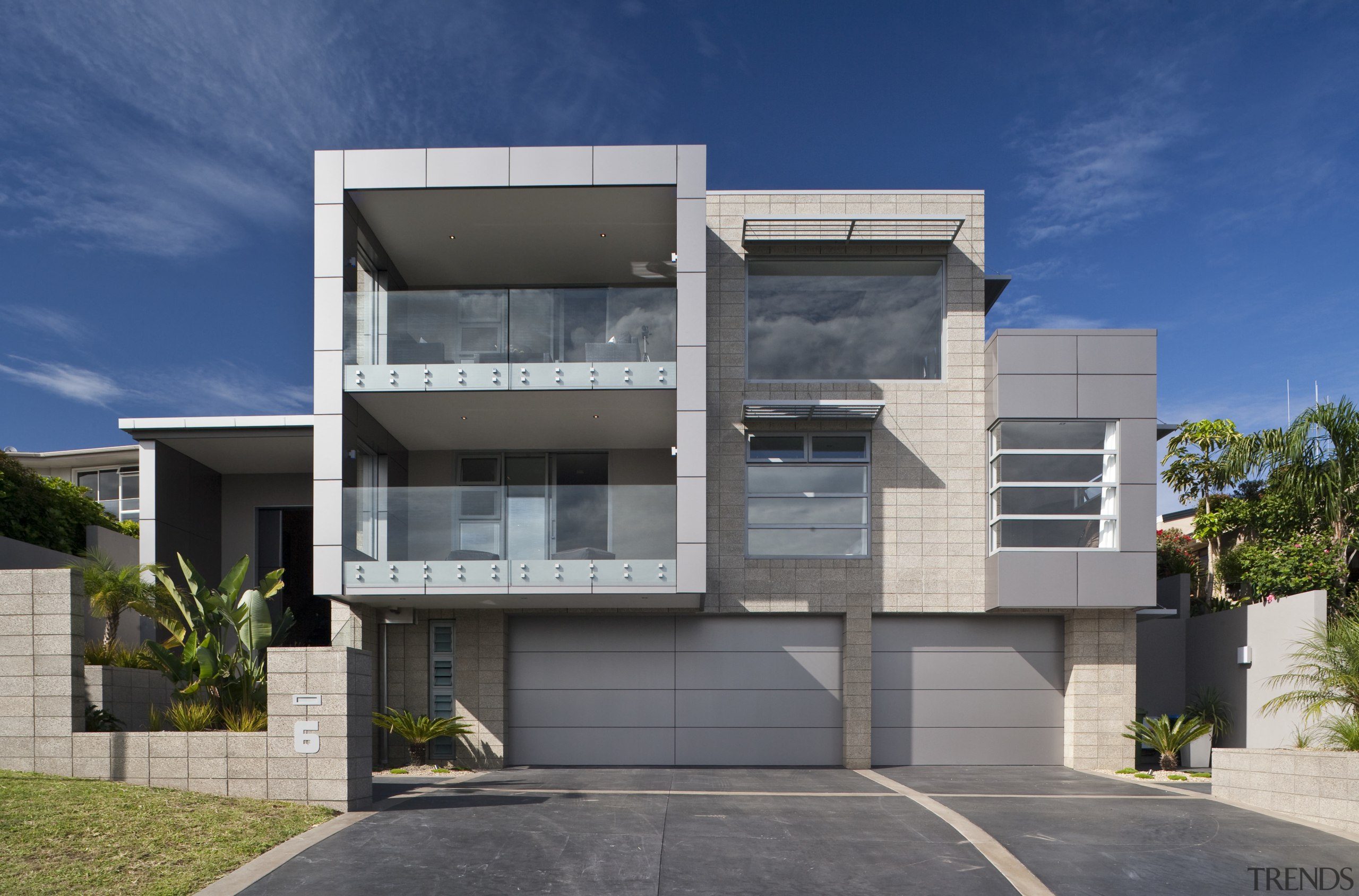 Exterior View of a home built by a architecture, building, commercial building, condominium, corporate headquarters, elevation, facade, home, house, official residence, property, real estate, residential area, gray, blue