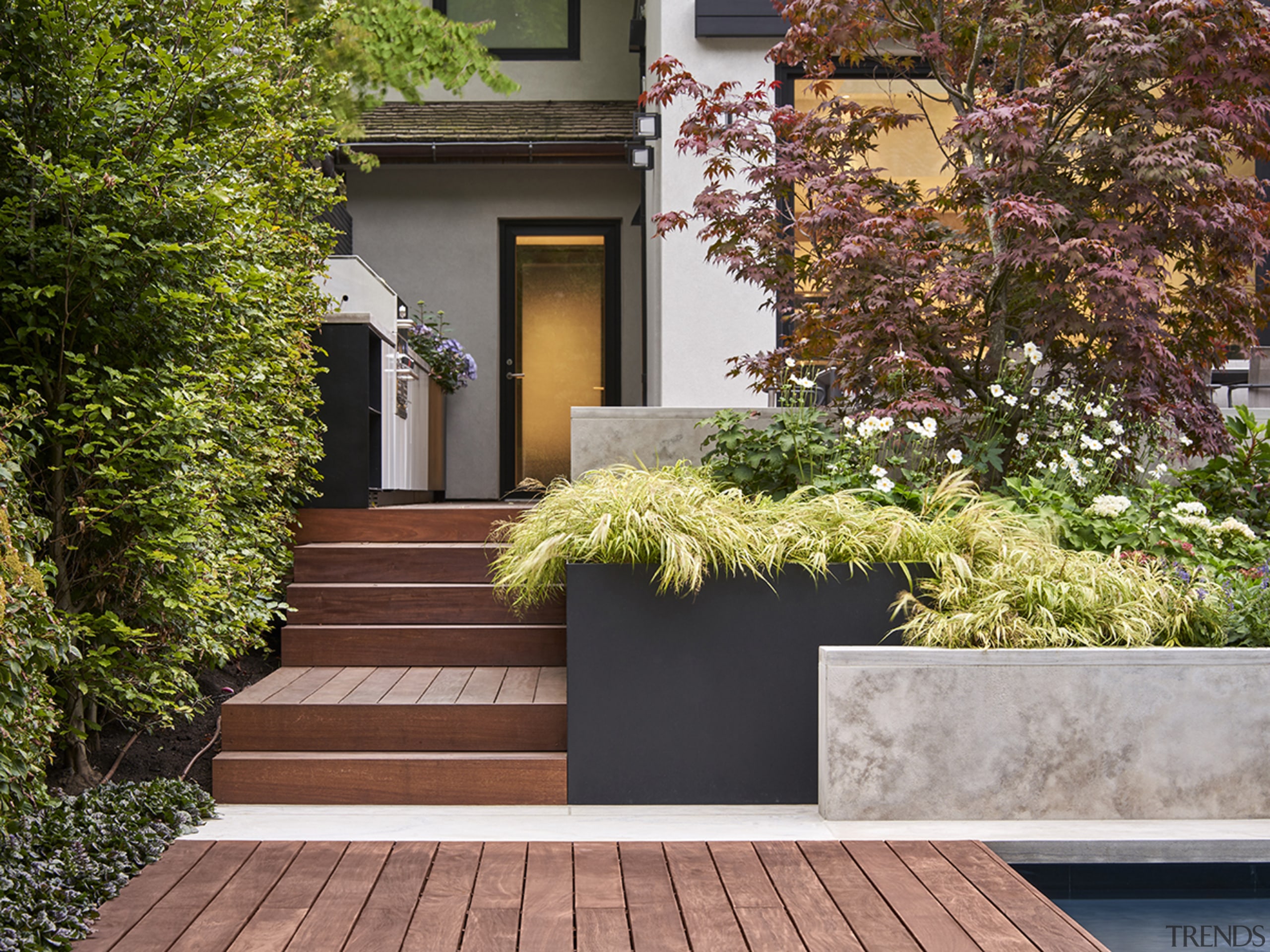 This landscaped garden and pool and dining area brown