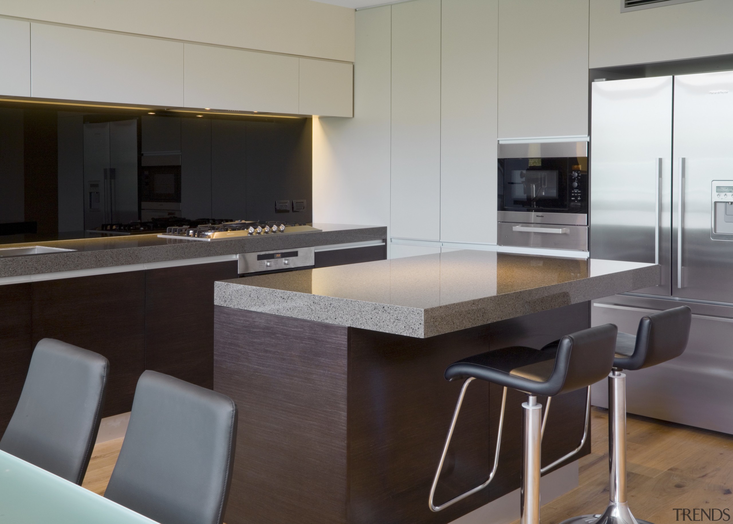 Image of the kitchen which features an island countertop, furniture, interior design, kitchen, real estate, table, gray, black