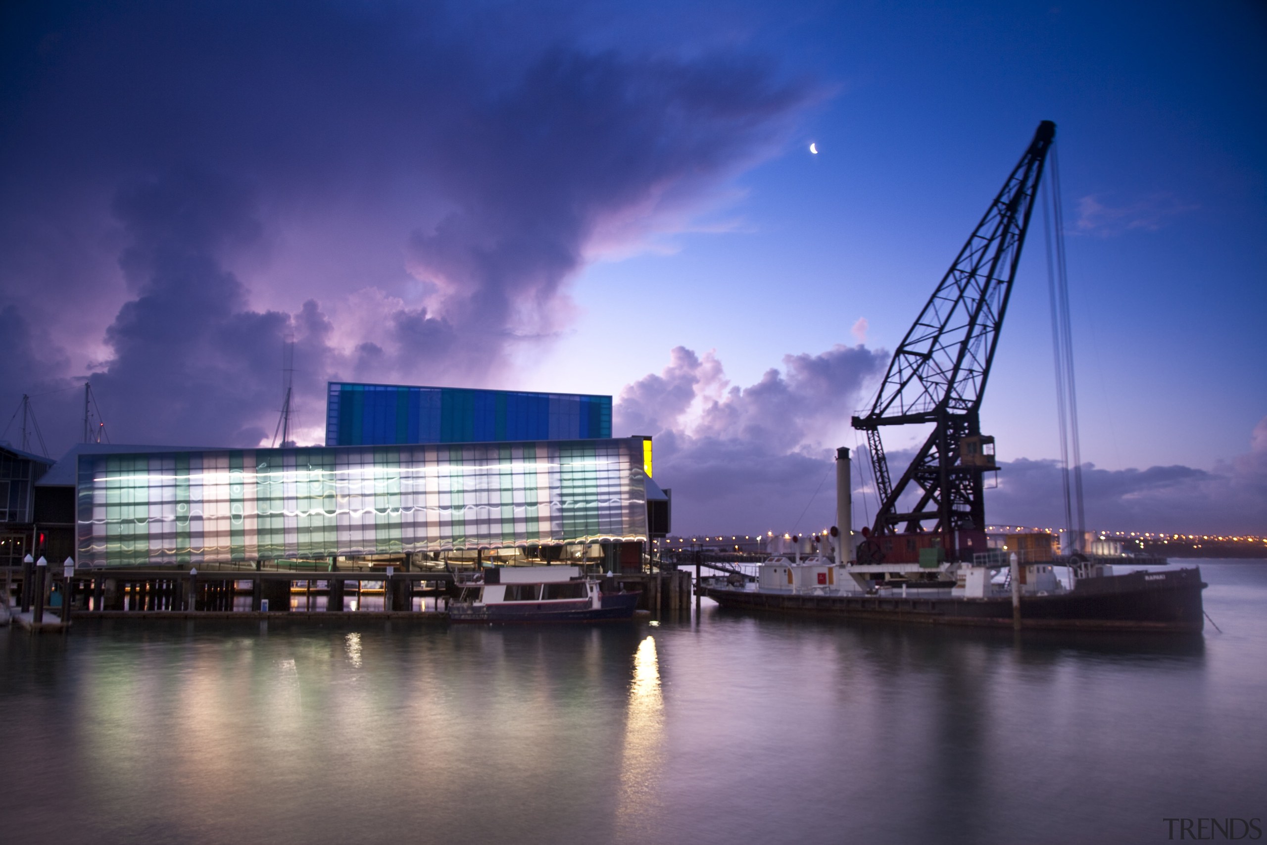 A yellow tower element signposts the museum building architecture, city, cityscape, cloud, dusk, evening, metropolis, night, reflection, sky, skyline, urban area, water, blue, purple