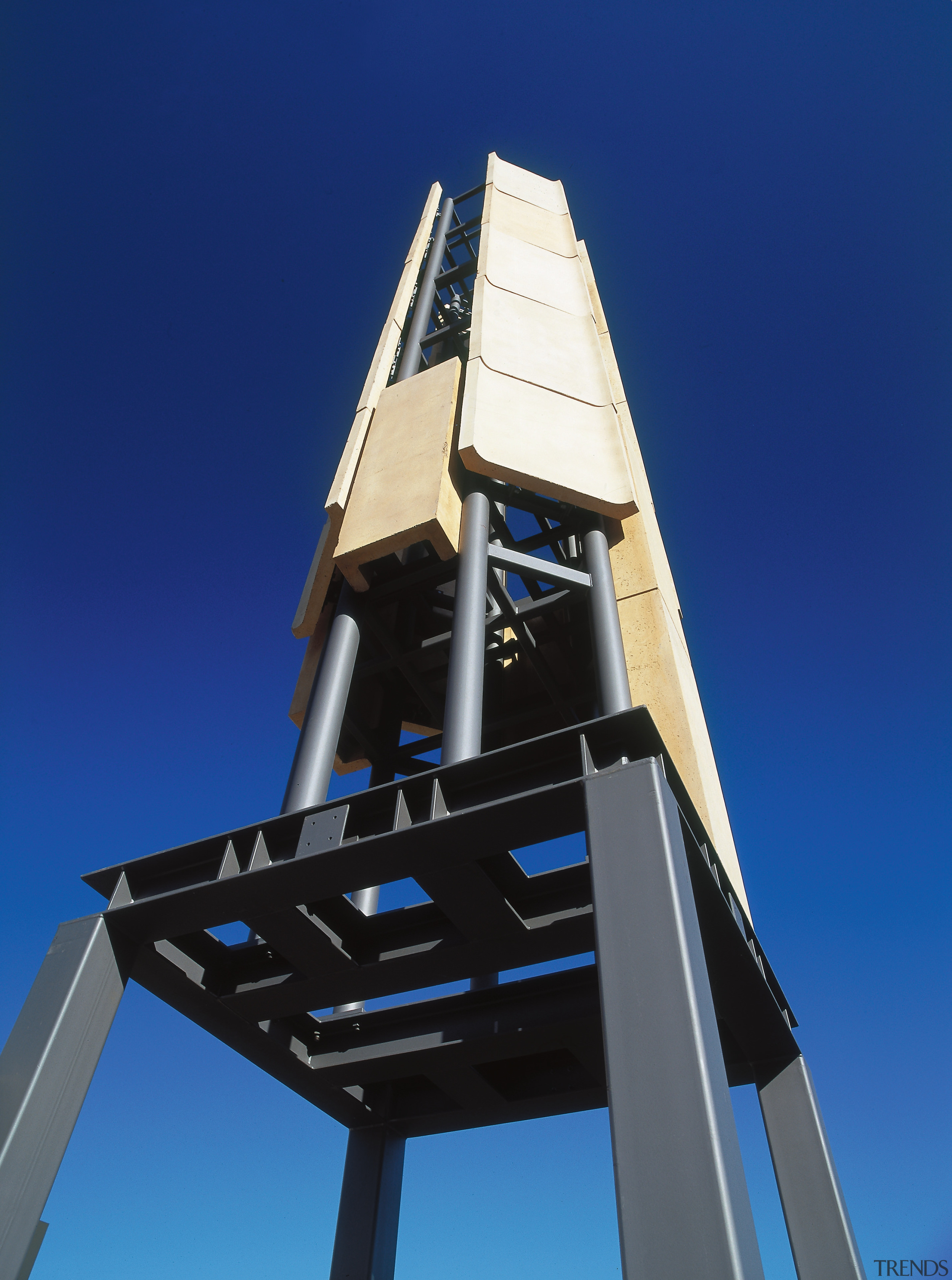 A view of a steel tower. - A building, observation tower, sky, structure, tower, blue