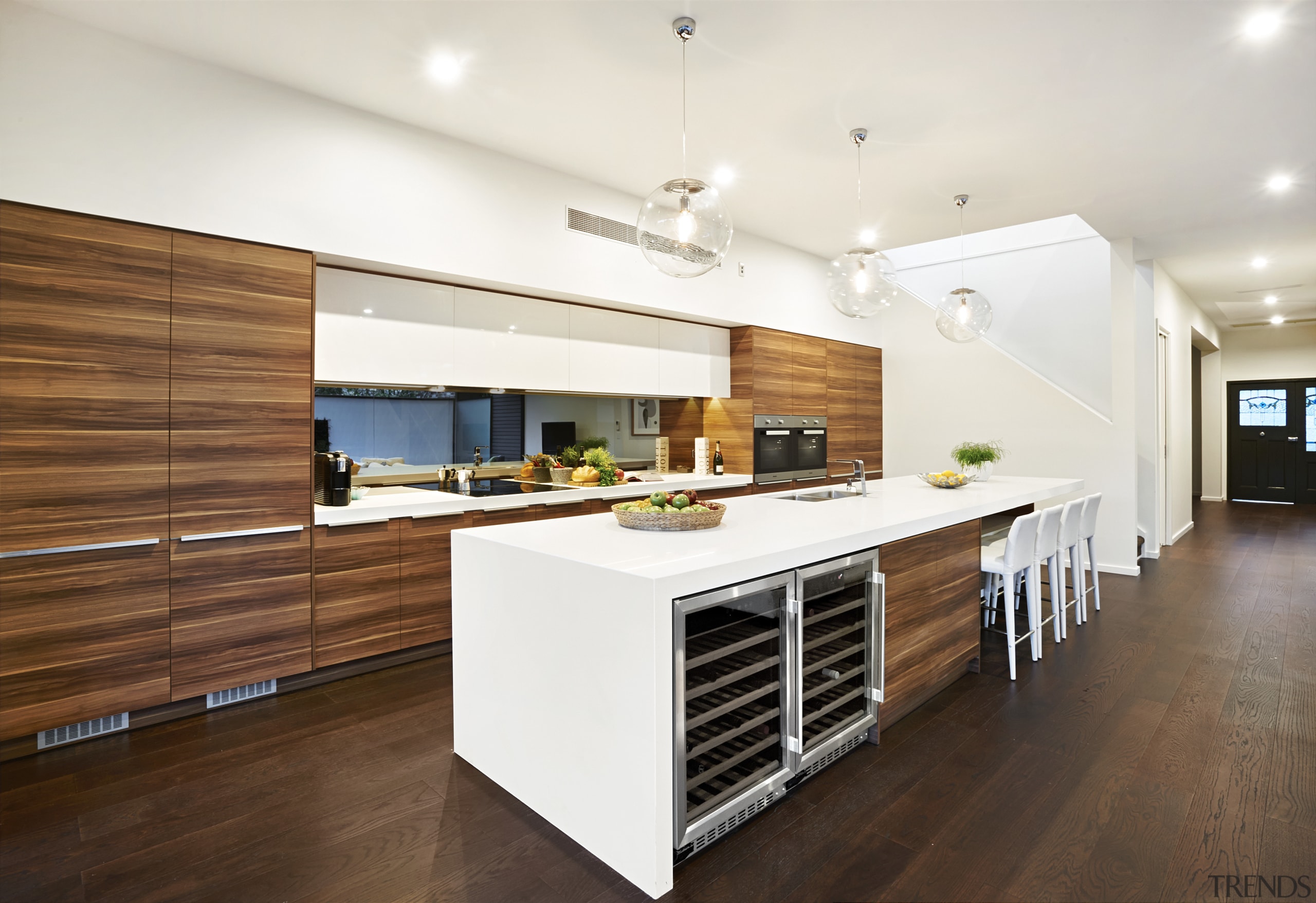 White benchtops and woodgrain laminate feature in this cabinetry, ceiling, countertop, cuisine classique, floor, flooring, hardwood, interior design, kitchen, laminate flooring, real estate, wood, wood flooring, white, brown