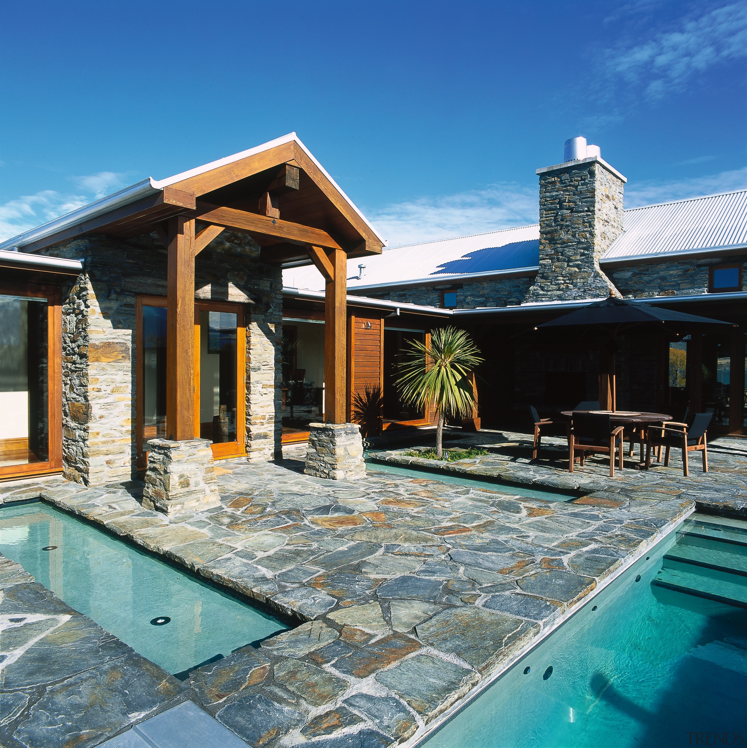 A view of the patio area, stone tiled estate, home, house, leisure, outdoor structure, property, real estate, roof, swimming pool, villa, water, teal