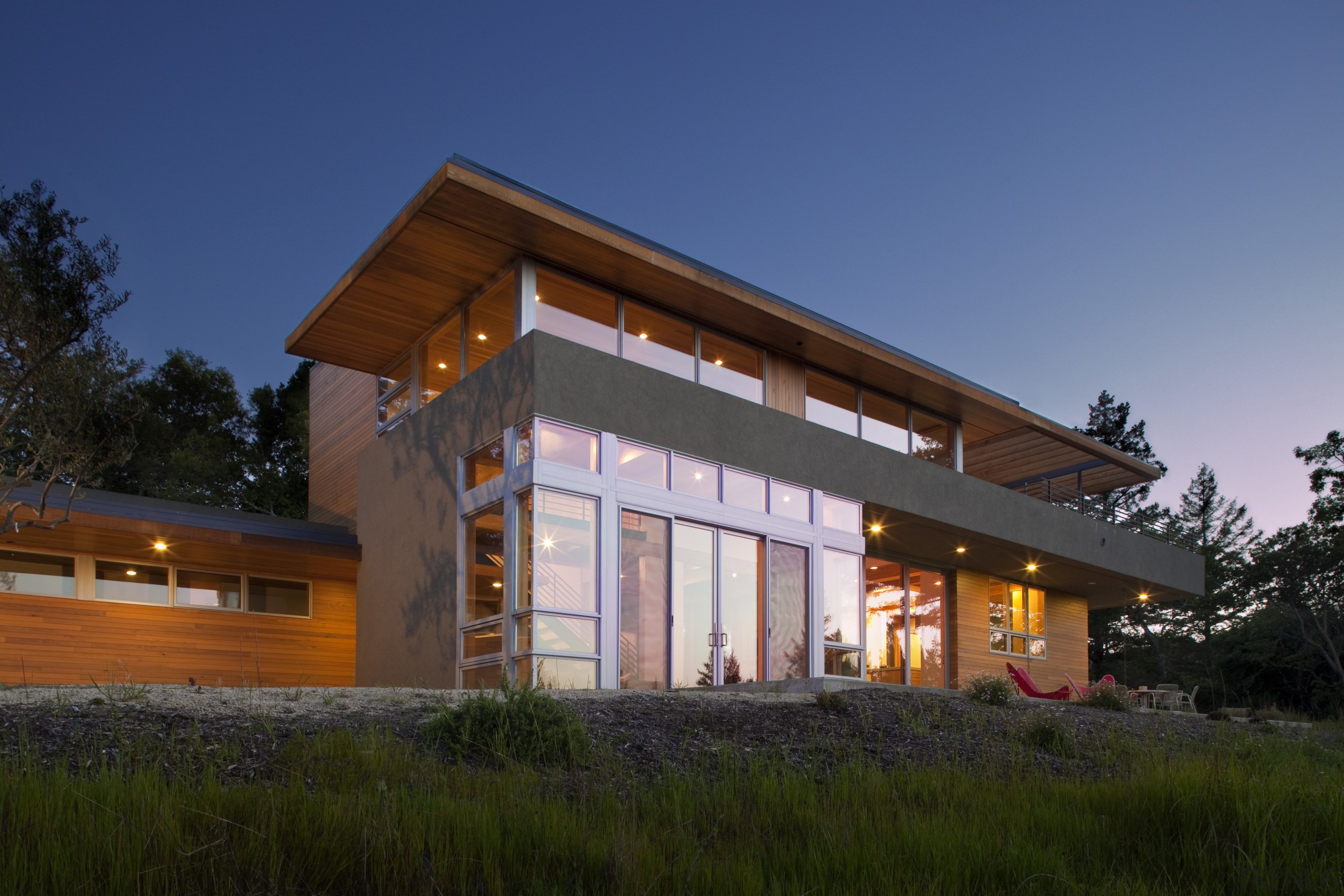 Designed by Robert Swatt, FAIA, Swatt | Miers architecture, cottage, evening, facade, farmhouse, home, house, lighting, real estate, residential area, roof, shed, siding, sky, wood, blue, brown