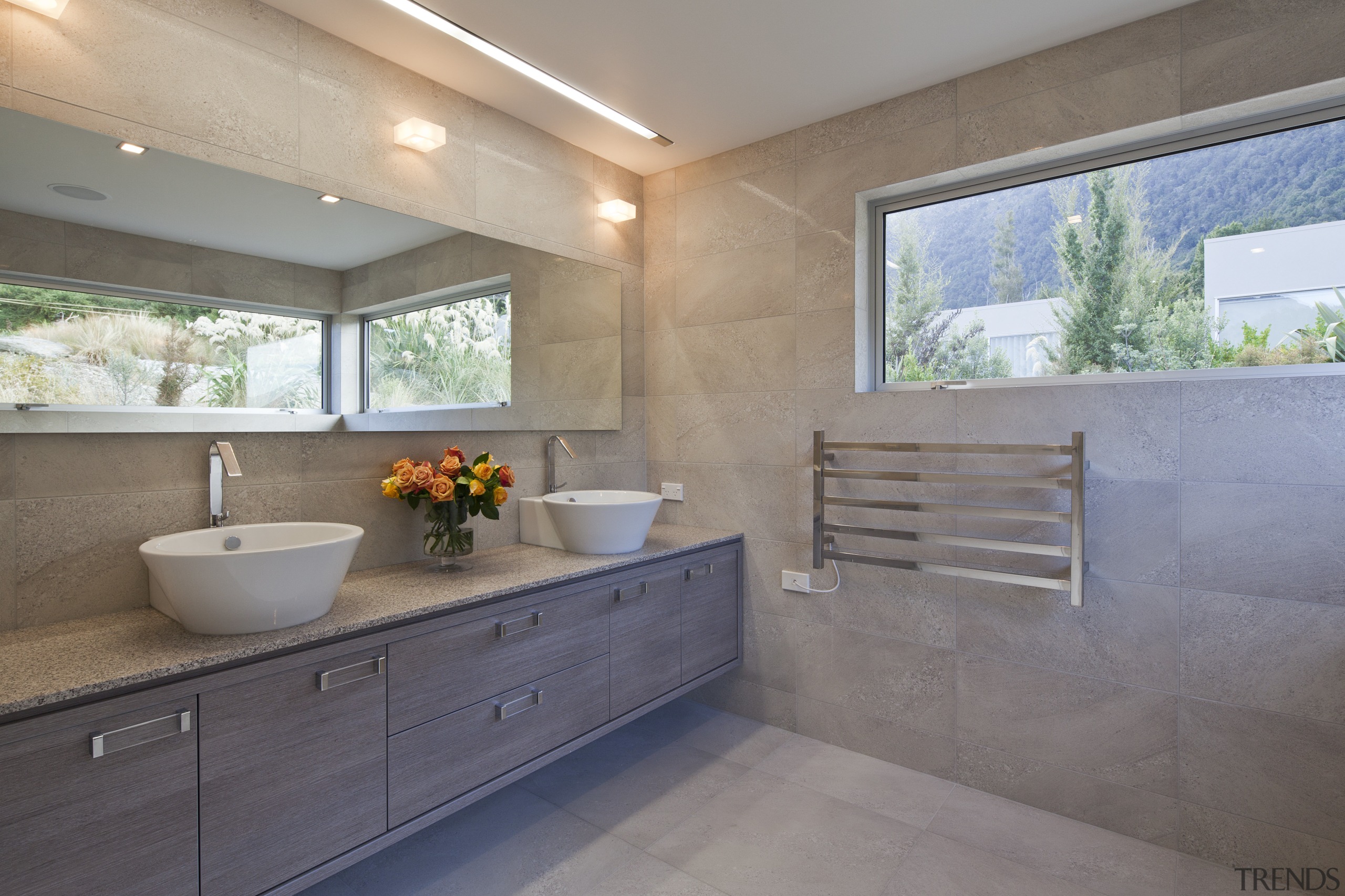 This contemporary bathroom is in a mountain-lakeside house bathroom, countertop, estate, home, house, interior design, property, real estate, room, window, gray