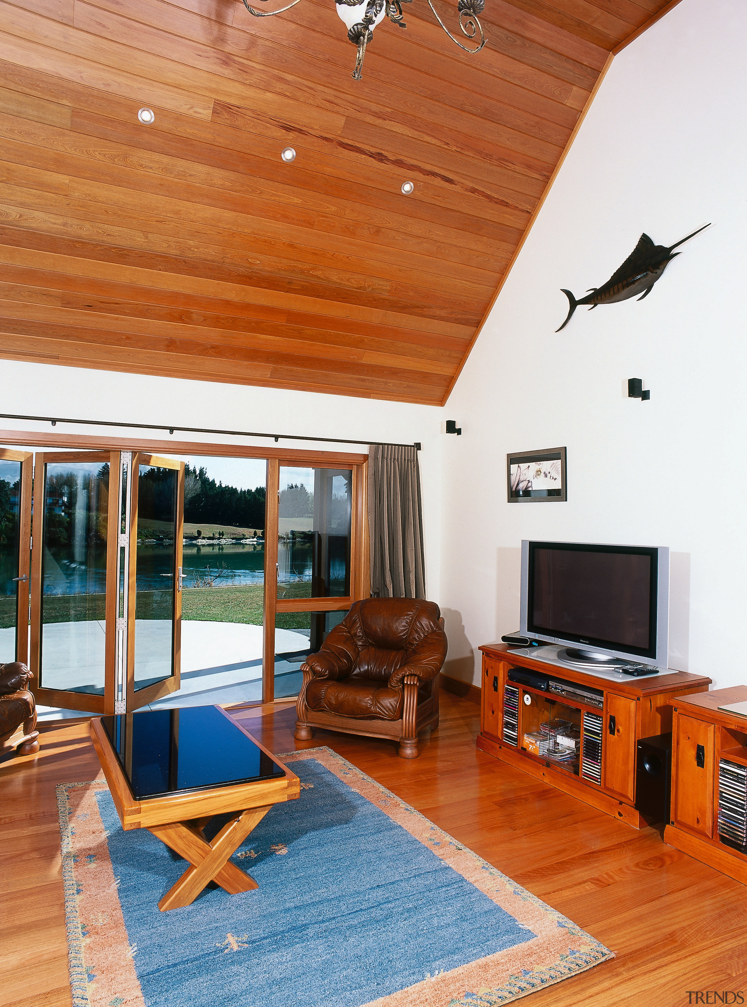 Family room with timber ceiling and flooring, armchair, ceiling, floor, flooring, hardwood, home, house, interior design, living room, property, real estate, room, wood, brown, white