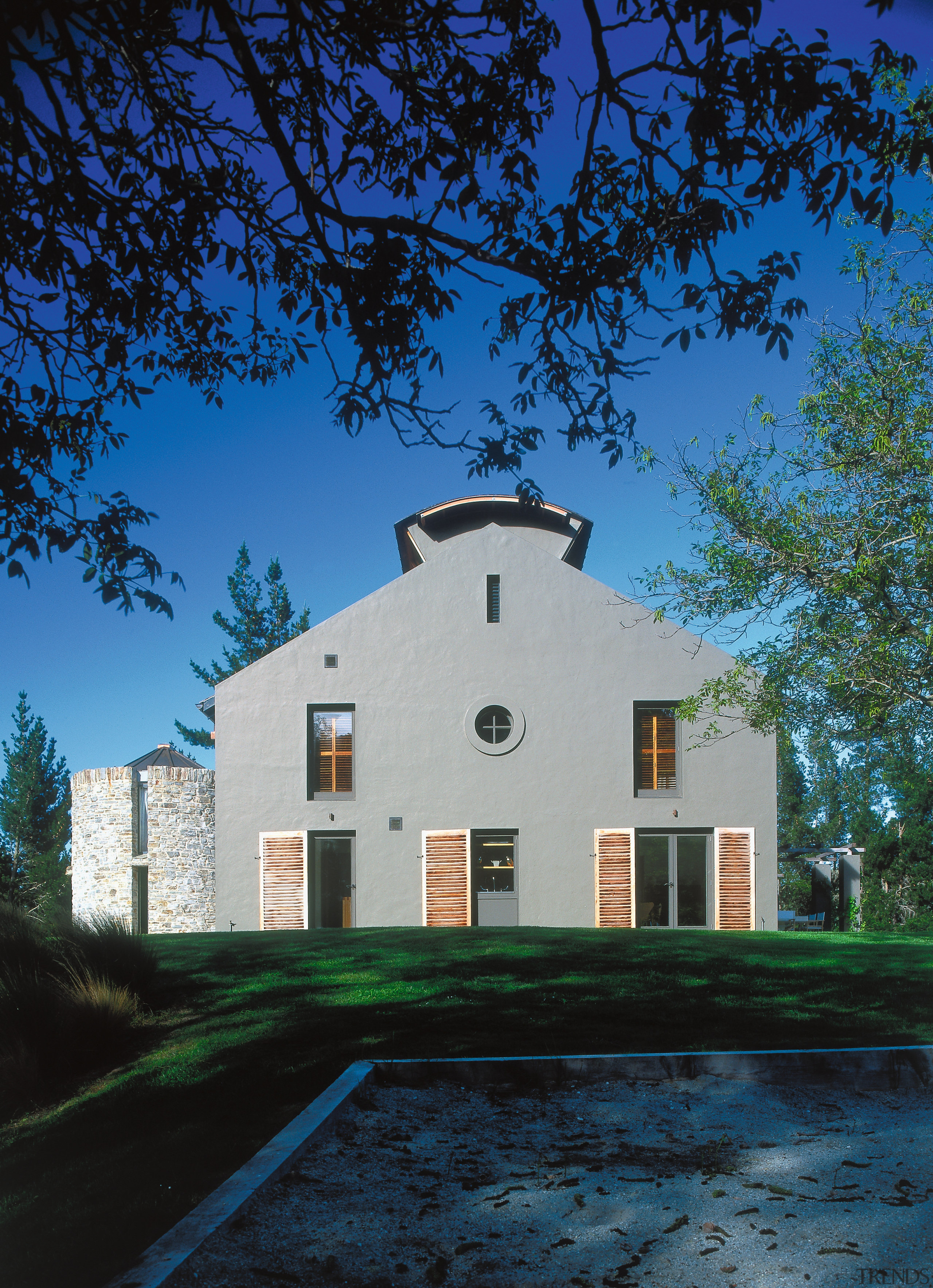 An exterior view of this rural home designed architecture, building, cloud, cottage, estate, facade, farmhouse, home, house, landmark, mansion, plant, property, real estate, residential area, sky, suburb, tree, black, blue