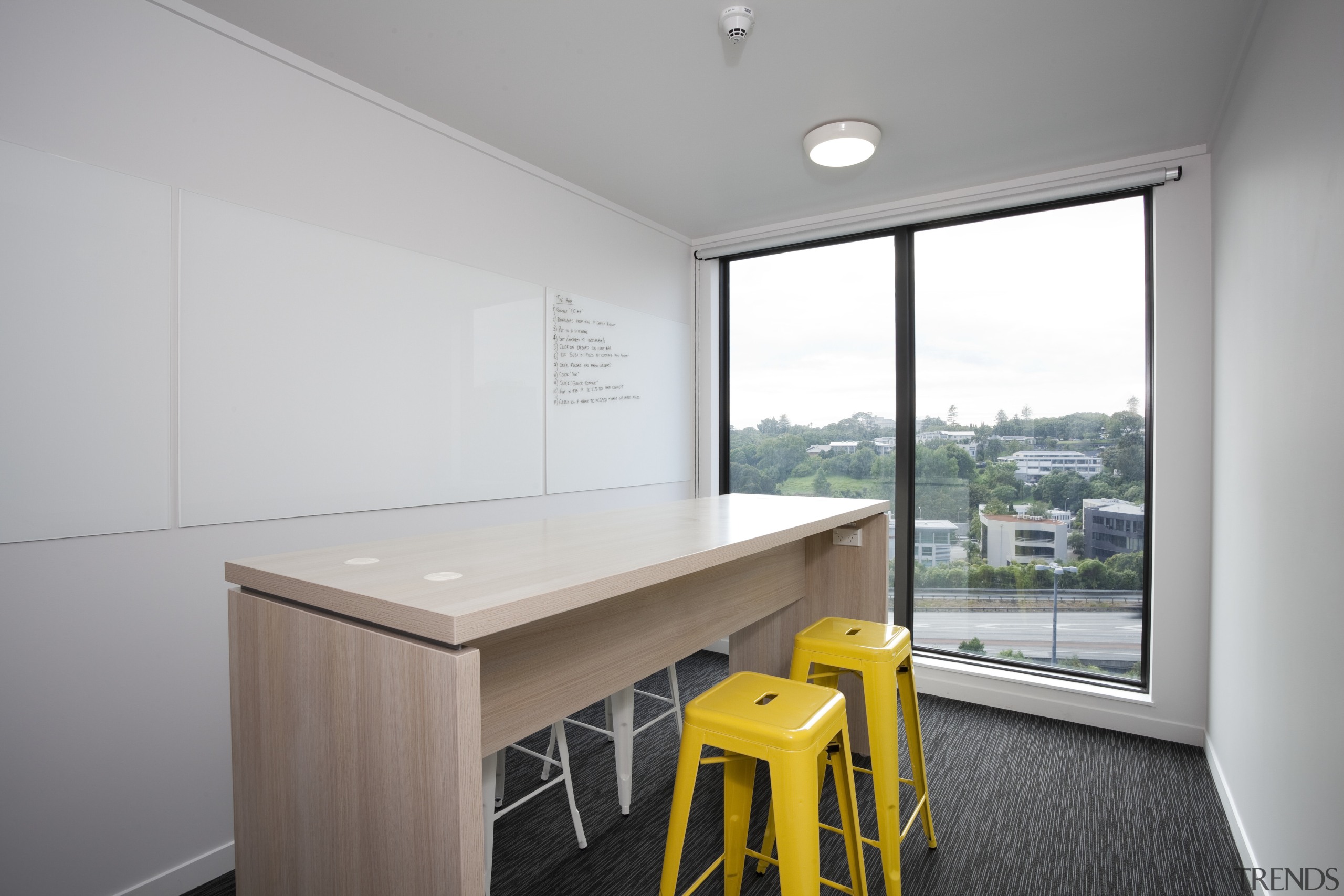 View of wooden desk with two yellow stools. architecture, home, house, interior design, office, property, real estate, gray, white