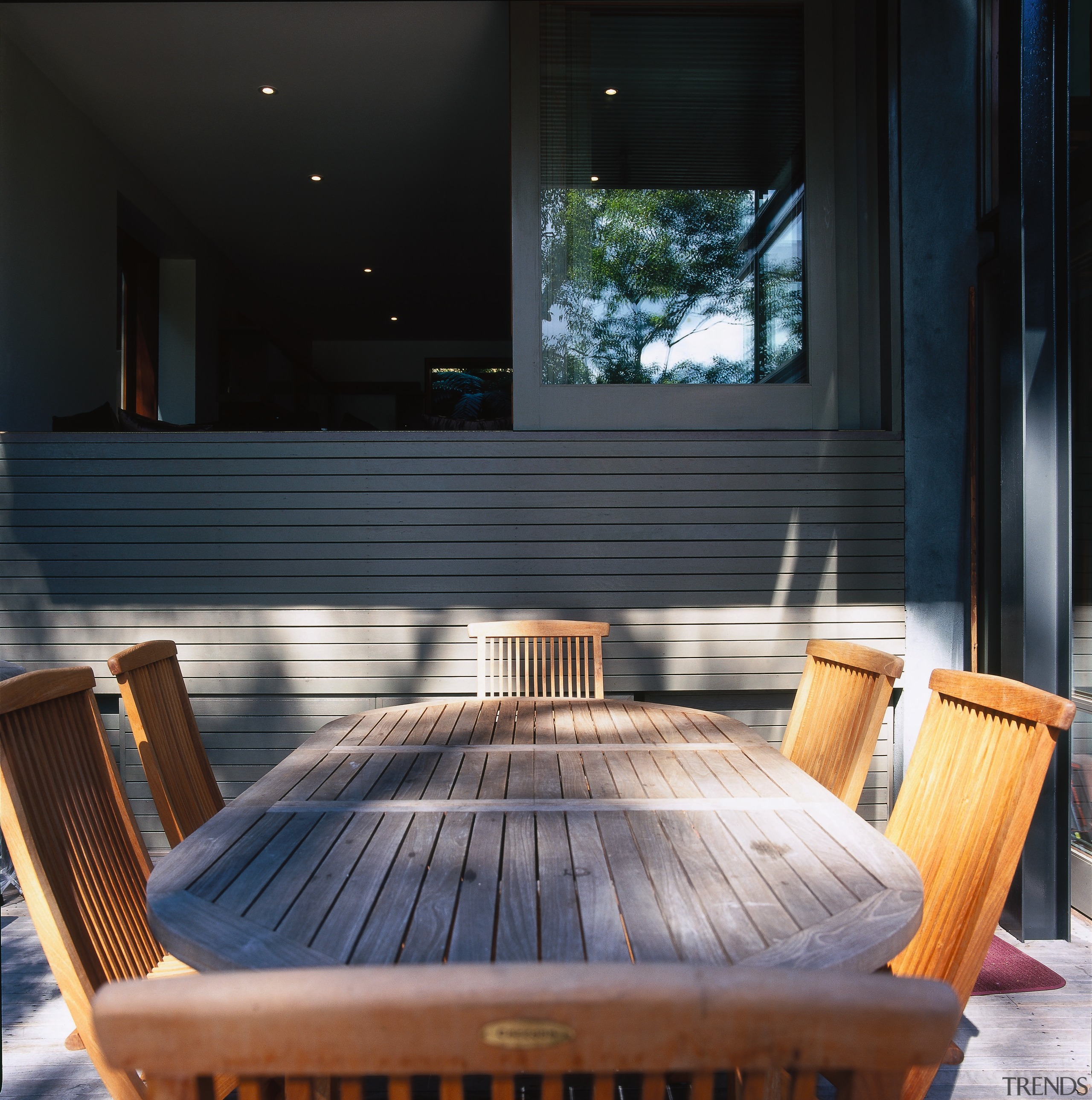 Wooden outdoor dining table and chairs on patio, architecture, chair, daylighting, floor, furniture, hardwood, interior design, lighting, outdoor furniture, table, wood, black