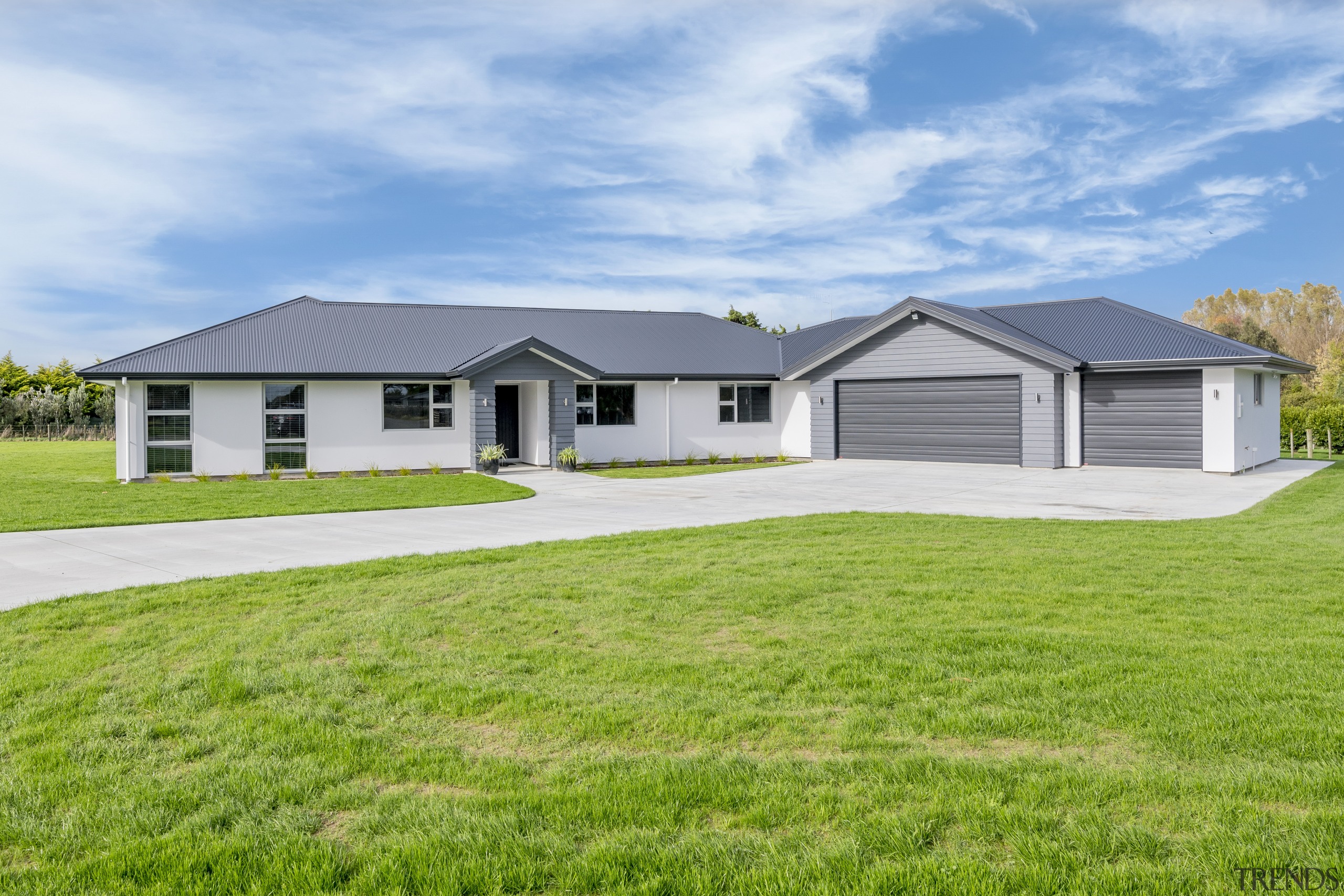 Long, light-filled and cleverly laid out, this classic-meets-modern cottage, elevation, estate, facade, farmhouse, grass, home, house, land lot, landscape, property, real estate, residential area, siding, yard, green, white