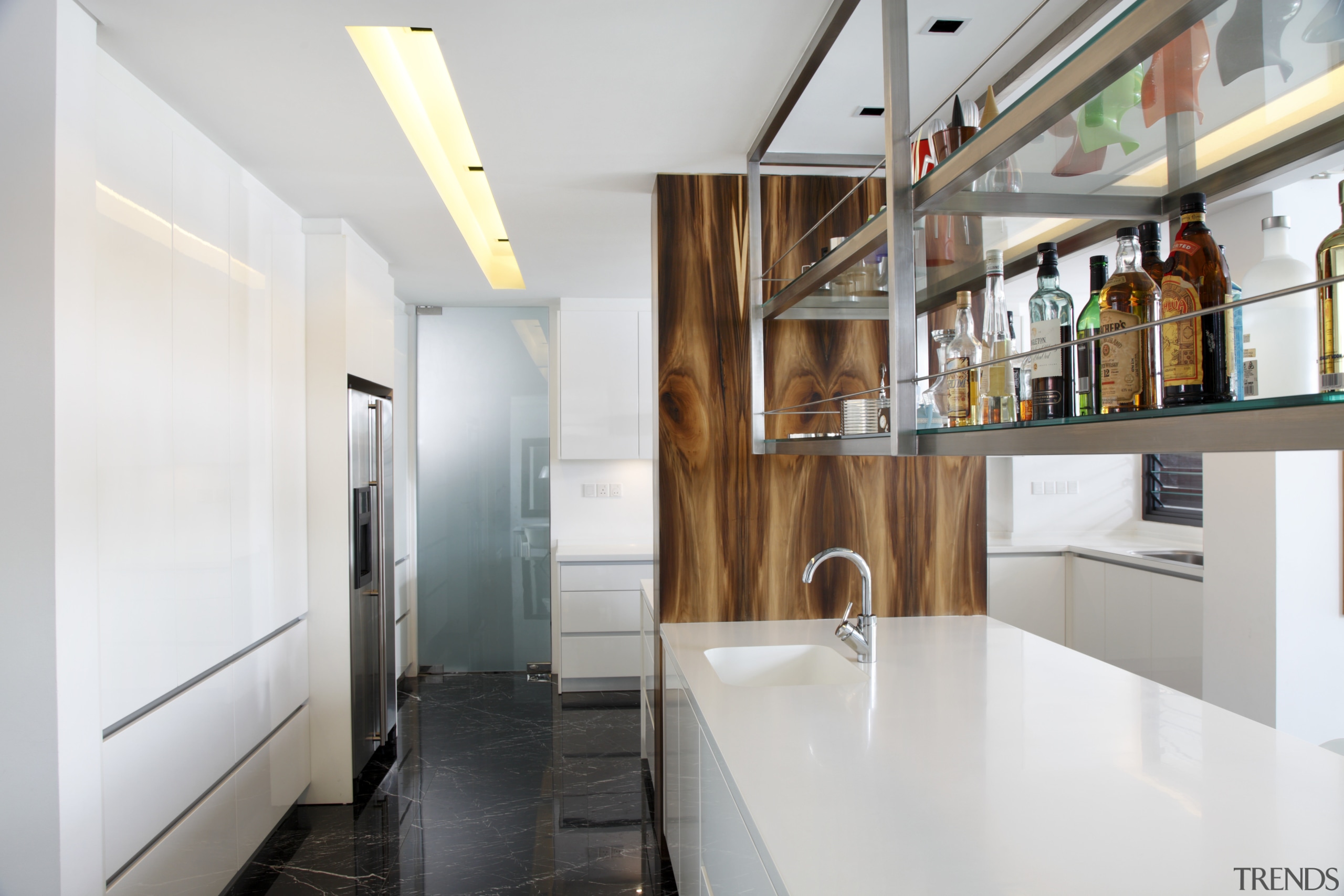 View of a bar style kitchen which features countertop, interior design, kitchen, real estate, white