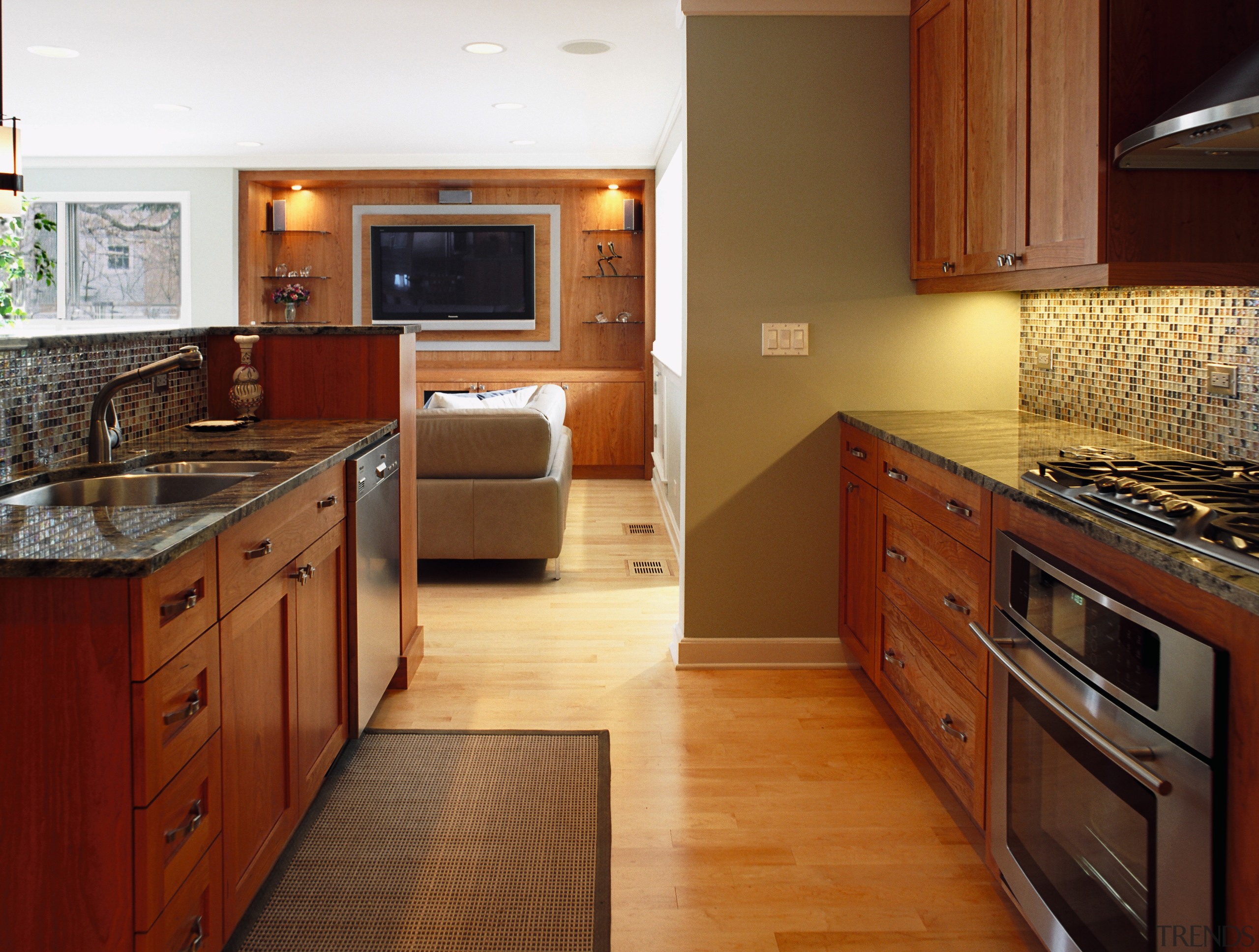 A view of the kitchen and living areas, cabinetry, countertop, cuisine classique, floor, flooring, hardwood, home, interior design, kitchen, real estate, room, wood, wood flooring, brown