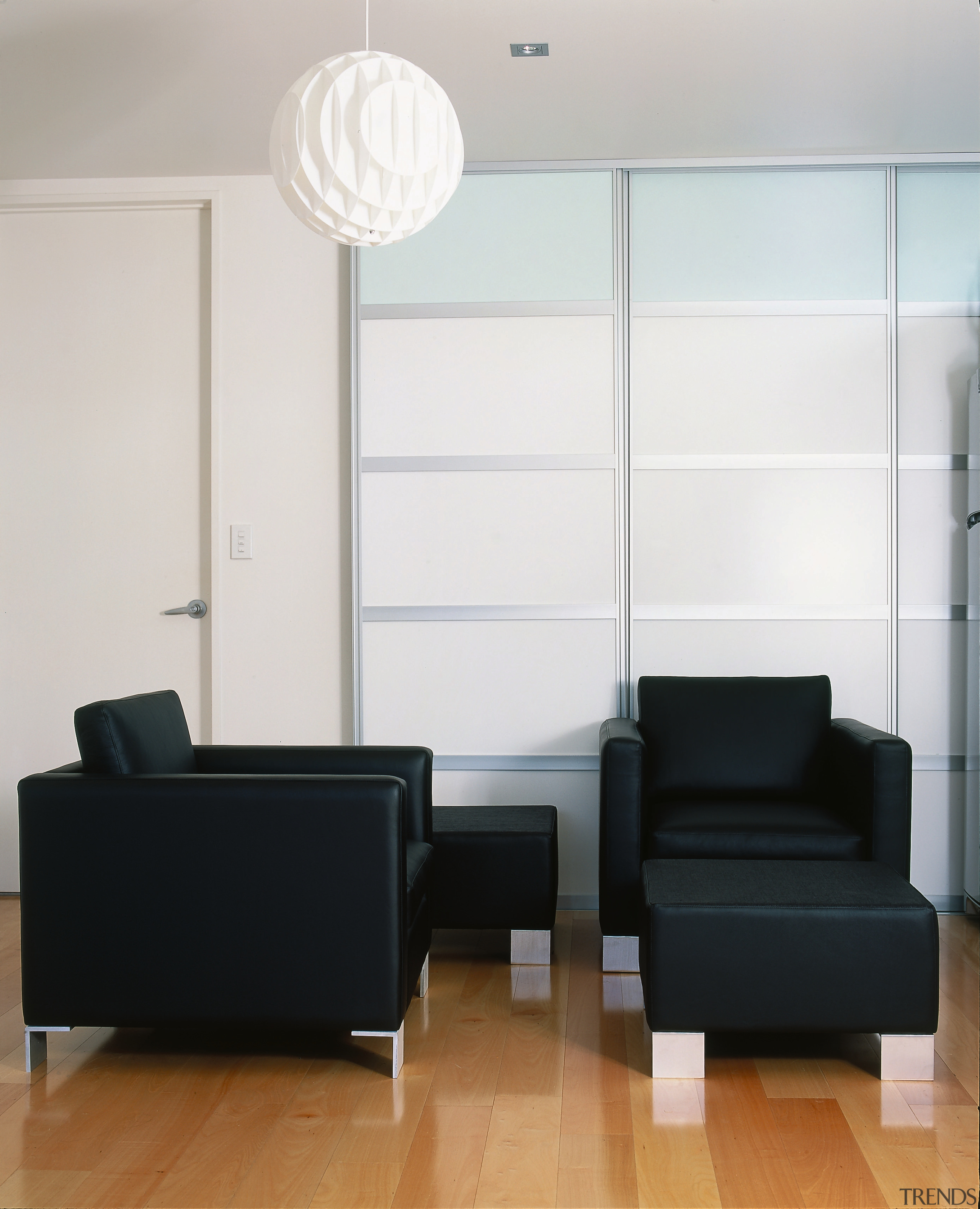 view of this lounge setting showing streamlined black angle, couch, floor, furniture, interior design, living room, product design, table, wall, white