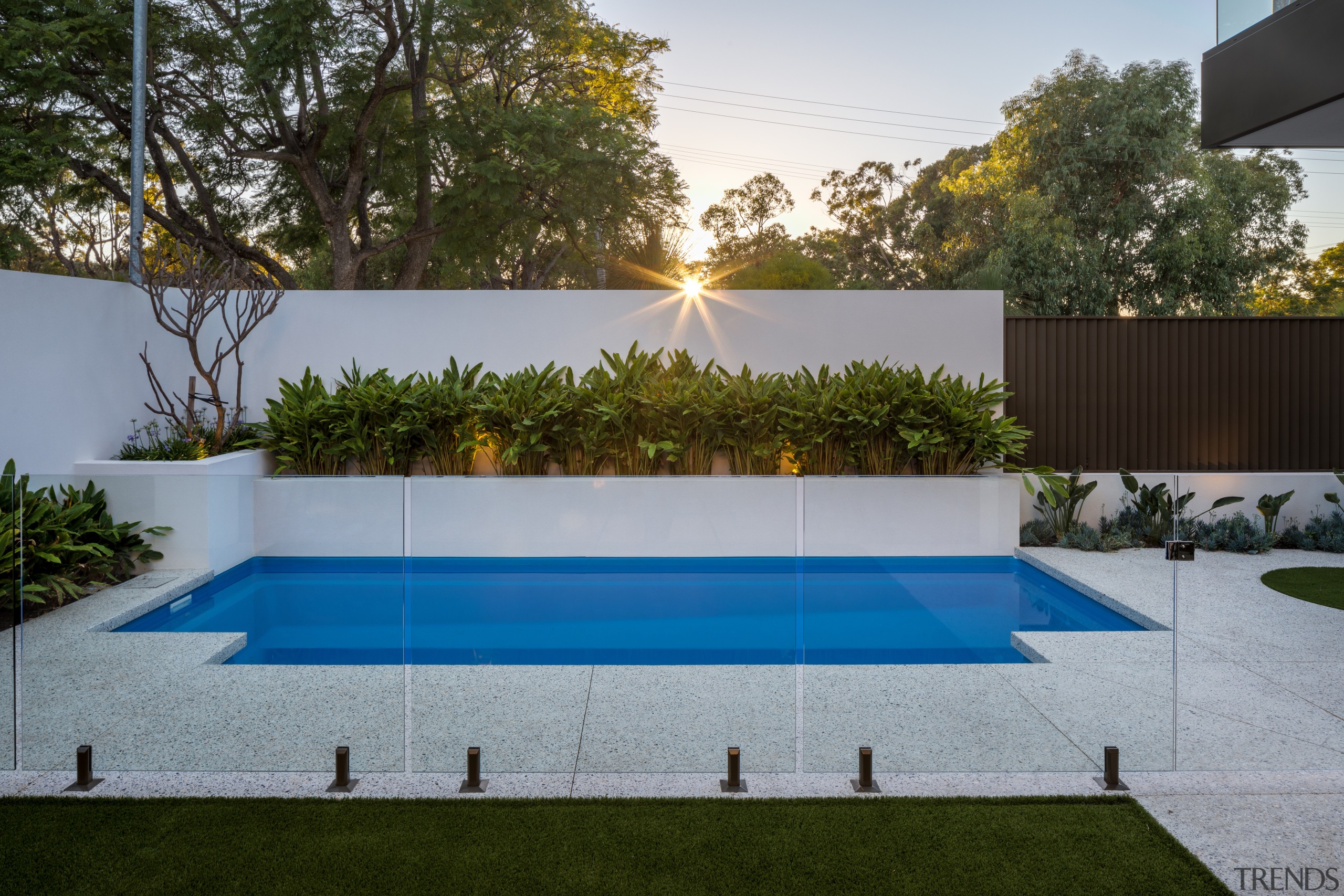 ​​​​​​​Glass pool balustrades provide safety without blocking the architecture, artificial turf, backyard, building, courtyard, estate, grass, home, house, landscape, landscaping, lawn, leisure, property, real estate, rectangle, reflecting pool, residential area, swimming pool, tree, wall, yard, gray, brown