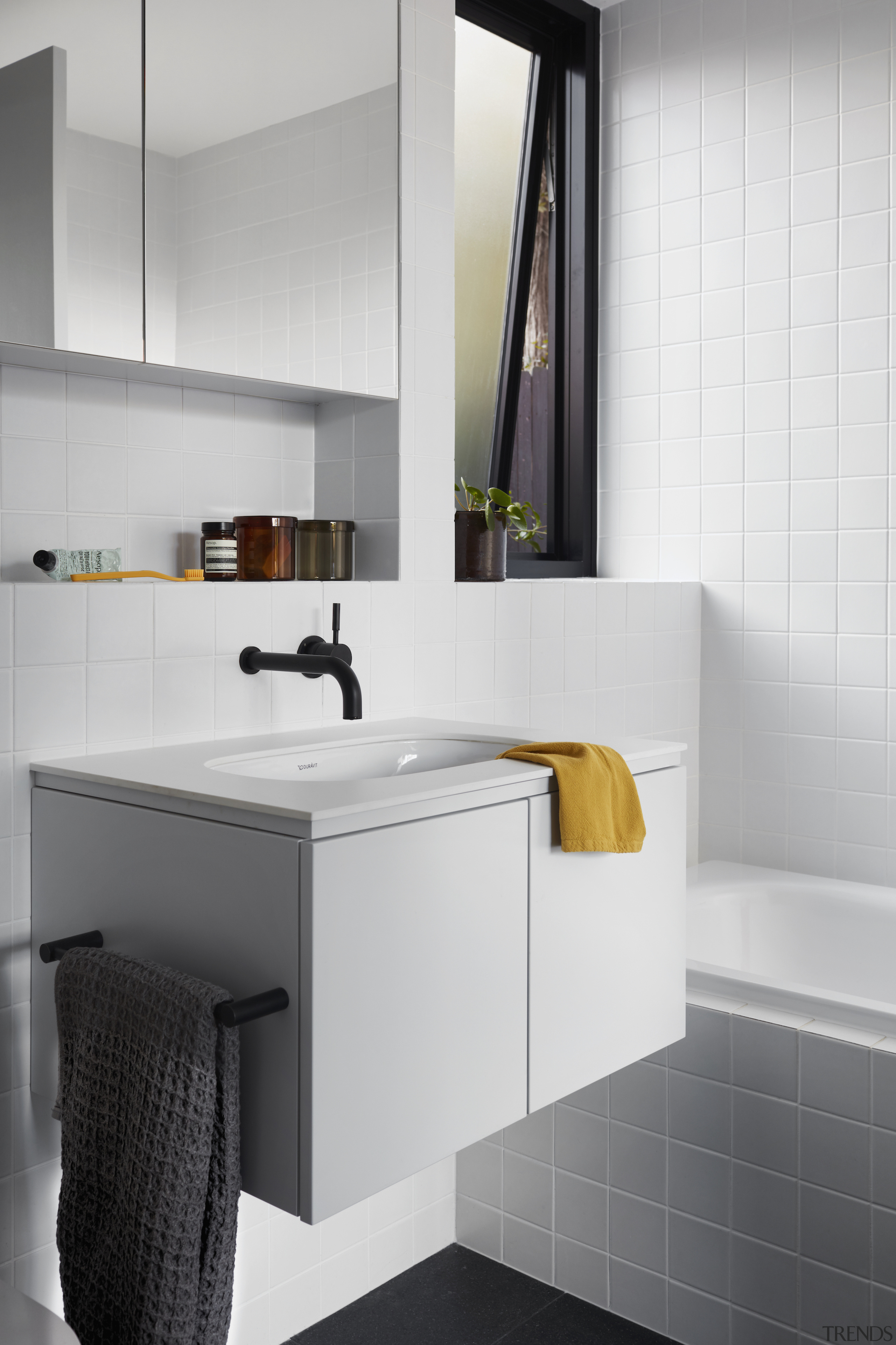 Black floors and black taps fight a wave 