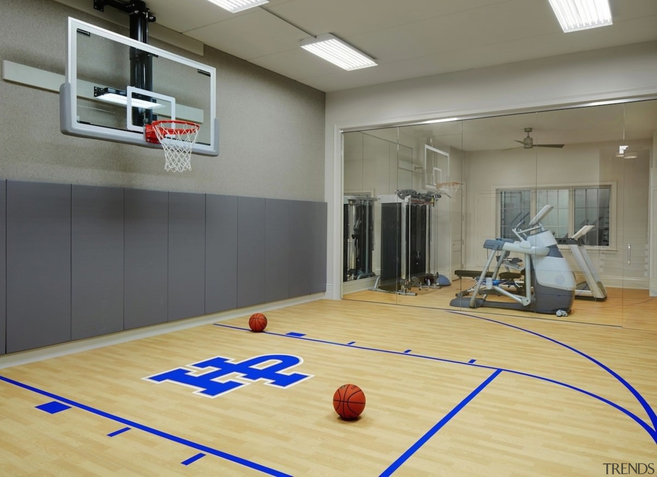 This basketball court/gym means you don't need to basketball court, floor, flooring, games, hardwood, indoor games and sports, interior design, laminate flooring, leisure centre, recreation room, room, sport venue, sports, structure, wood, wood flooring, gray, orange