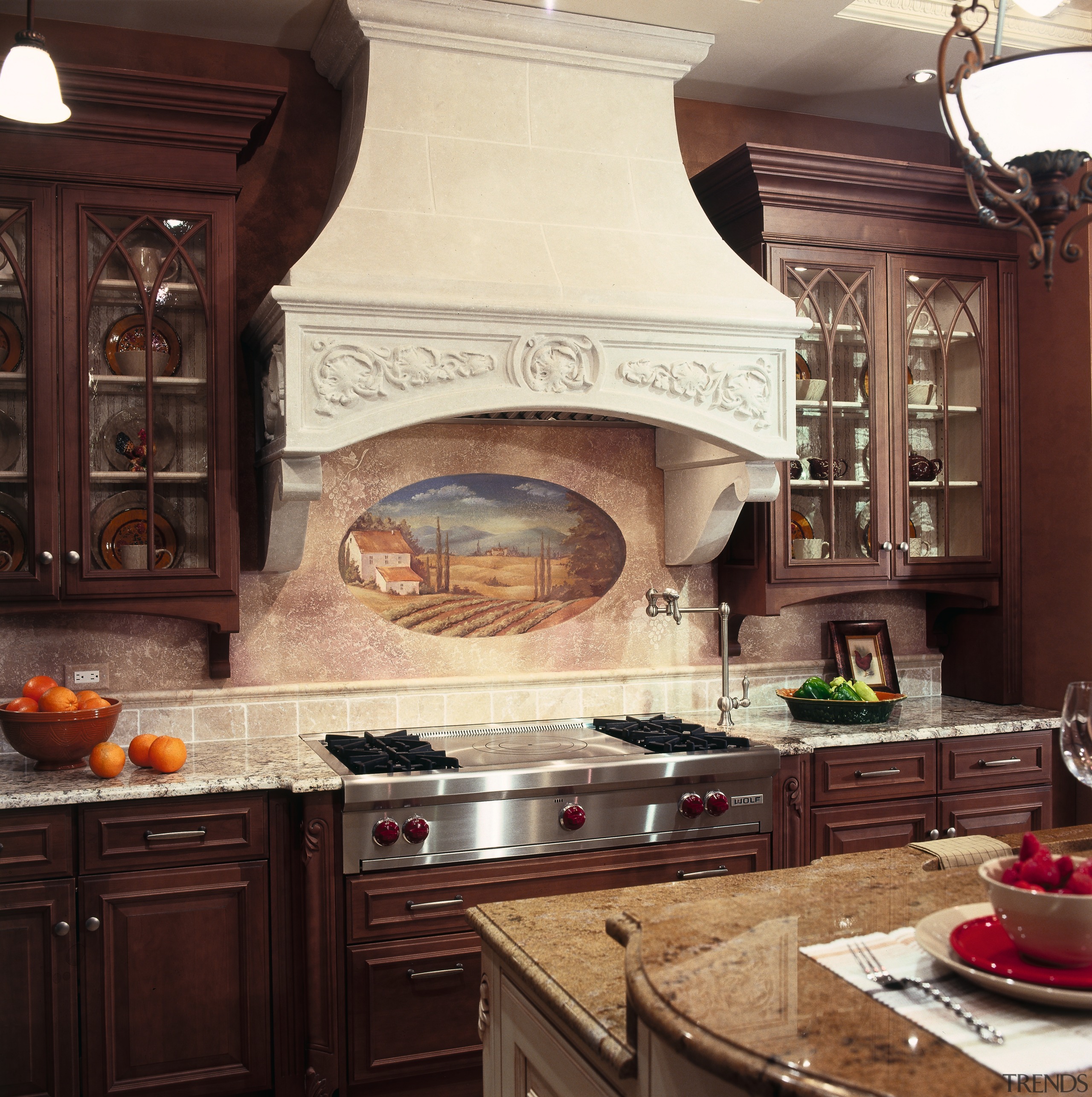 A view of this traditional kitchen featuring Ovation cabinetry, countertop, cuisine classique, home appliance, interior design, kitchen, kitchen appliance, kitchen stove, red, orange