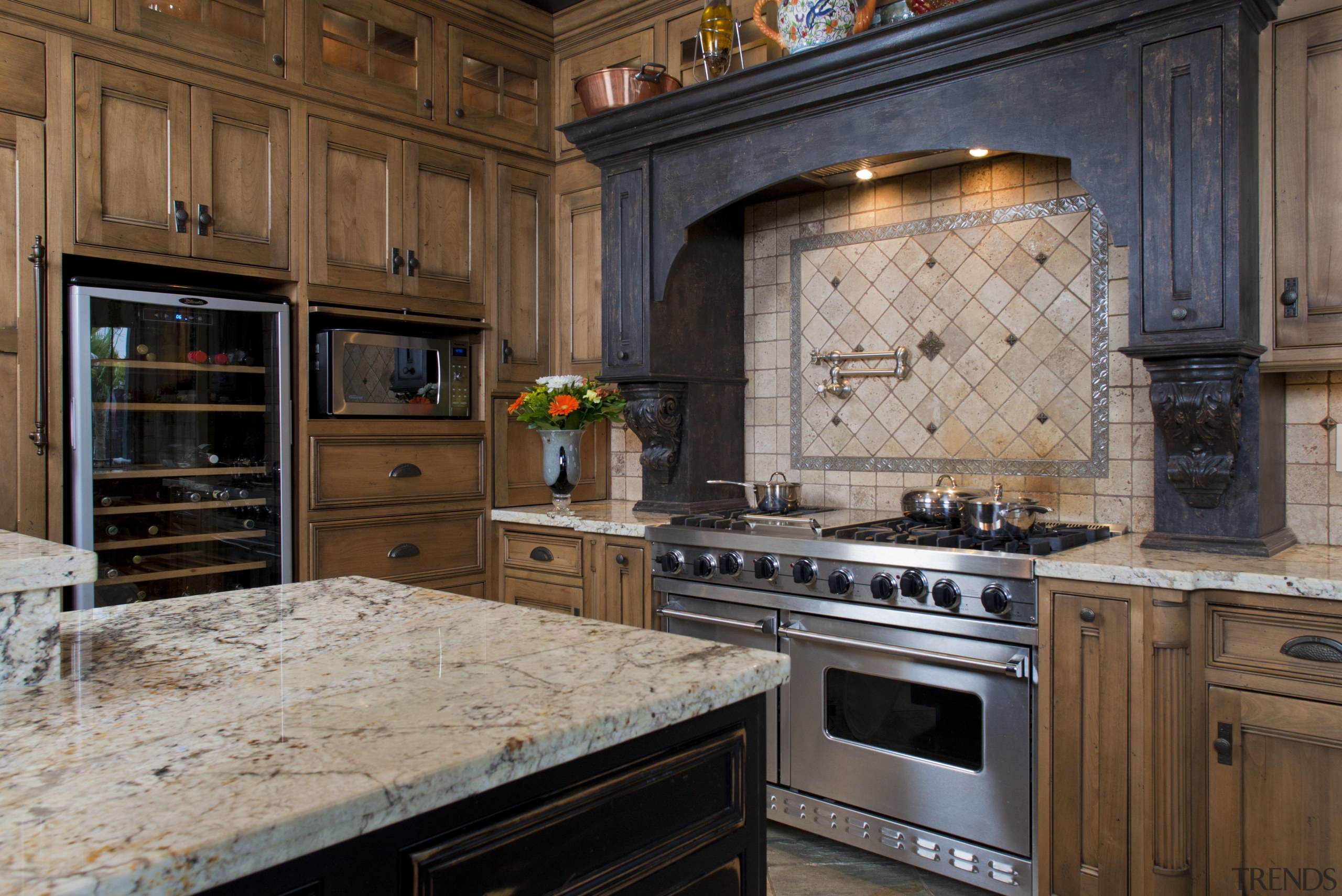 View of kitchen with aged look, featuring internally cabinetry, countertop, cuisine classique, flooring, hardwood, home appliance, interior design, kitchen, kitchen appliance, room, black, brown, gray