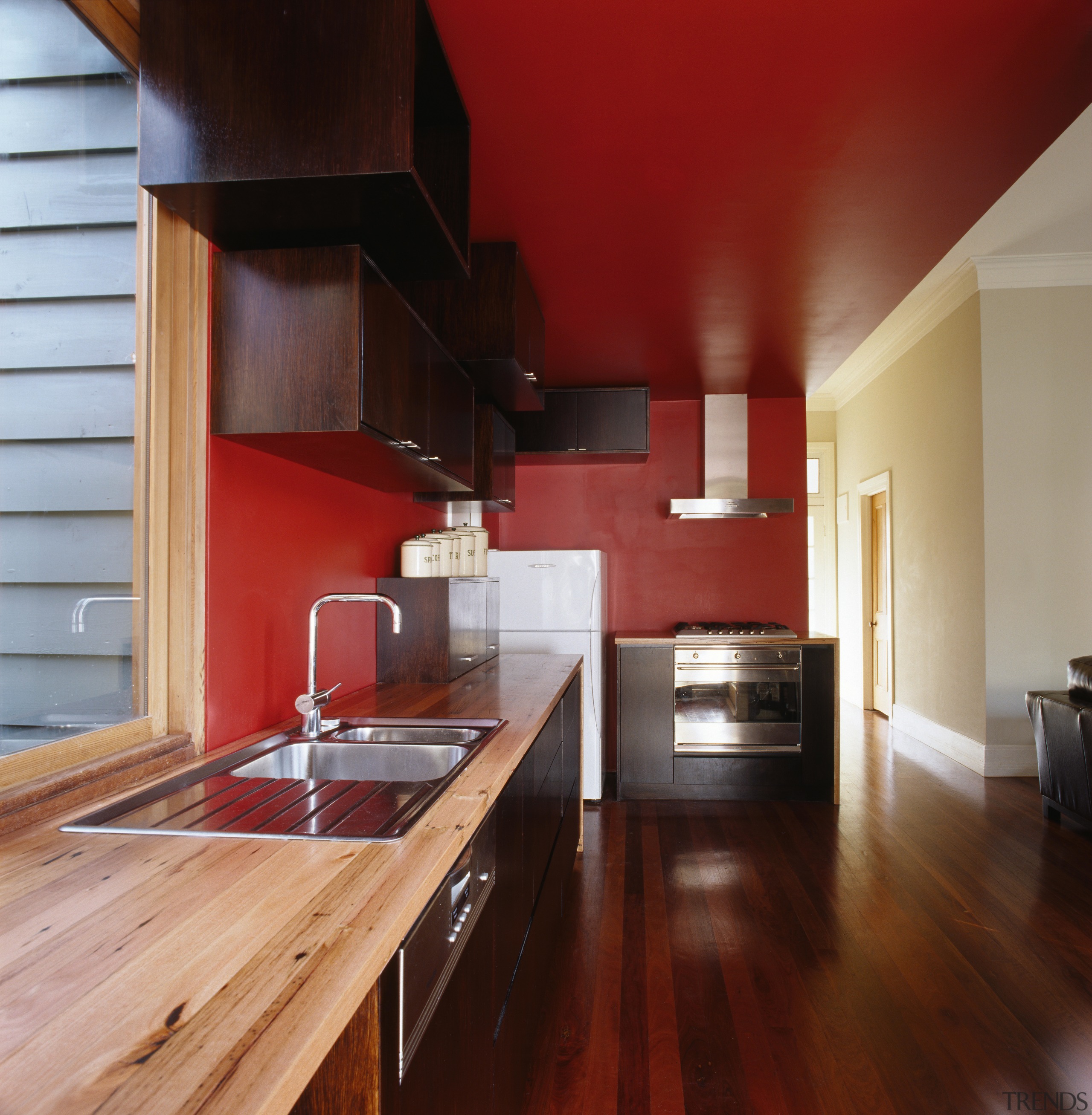 A view of the kitchen area, wooden flooring, architecture, cabinetry, ceiling, countertop, floor, flooring, hardwood, house, interior design, kitchen, laminate flooring, real estate, room, wood, wood flooring, red